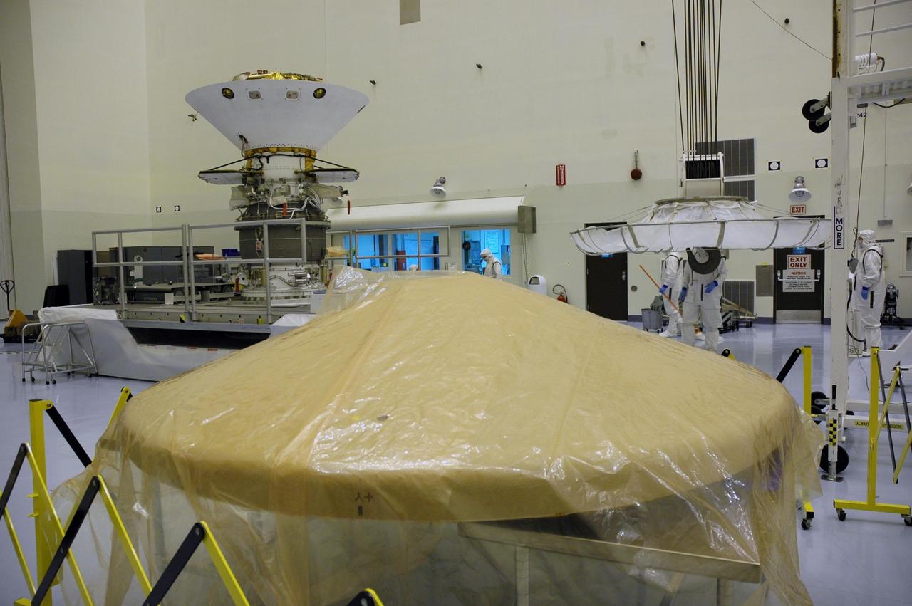 KENNEDY SPACE CENTER, Fla. -- In the Payload Hazardous Servicing Facility, the heat shield (foreground) for the Phoenix Mars Lander spacecraft is ready for installation. Targeted for launch from Cape Canaveral Air Force Station on Aug. 3, Phoenix will land in icy soils near the north polar permanent ice cap of Mars and explore the history of the water in these soils and any associated rocks, while monitoring polar climate. Landing on Mars is planned in May 2008 on arctic ground where a mission currently in orbit, Mars Odyssey, has detected high concentrations of ice just beneath the top layer of soil. Photo credit: NASA/Troy Cryder