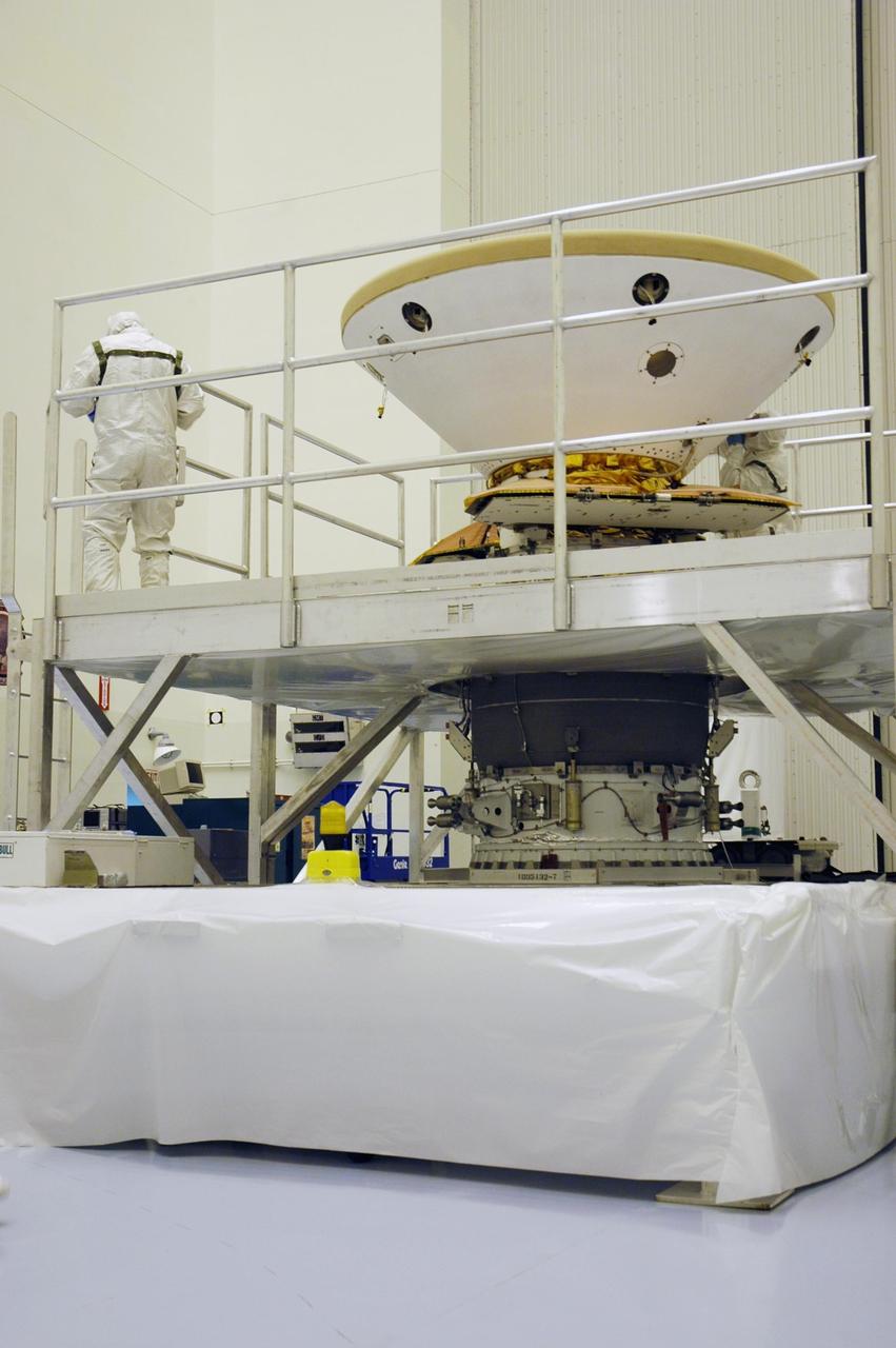KENNEDY SPACE CENTER, Fla. -- In the Payload Hazardous Servicing Facility, the Phoenix Mars Lander spacecraft rests with its heat shield installed. Targeted for launch from Cape Canaveral Air Force Station on Aug. 3, Phoenix will land in icy soils near the north polar permanent ice cap of Mars and explore the history of the water in these soils and any associated rocks, while monitoring polar climate. Landing on Mars is planned in May 2008 on arctic ground where a mission currently in orbit, Mars Odyssey, has detected high concentrations of ice just beneath the top layer of soil. Photo credit: NASA/Troy Cryder