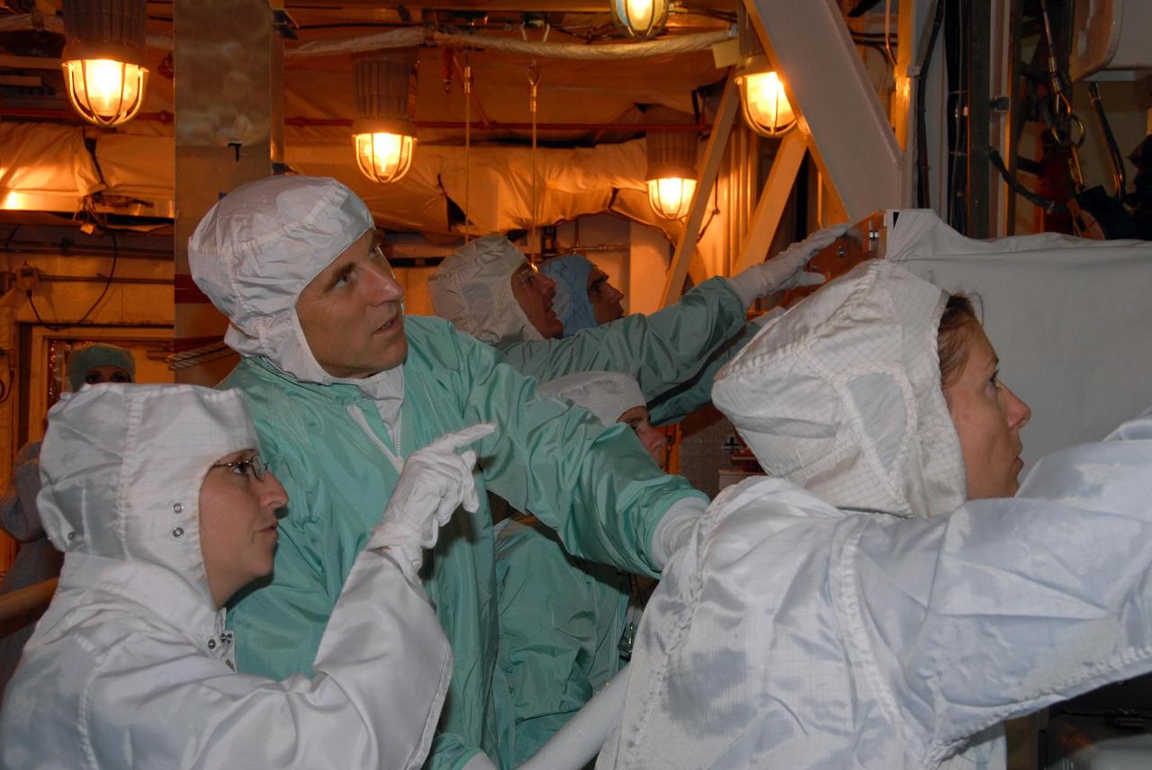 KENNEDY SPACE CENTER, Fla. -- STS-118 crew members get a close look at the payloads installed in Space Shuttle Endeavour. Seen in the foreground are Mission Specialists Dave Williams (center), who represents the Canadian Space Agency, and Tracy Caldwell (right). In the background is Mission Specialist Rick Mastracchio. The STS-118 crew has been at Kennedy for terminal countdown demonstration test activities that also include M-113 training, emergency egress training at the pad and a simulated launch countdown. The mission is the 22nd flight to the International Space Station and Space Shuttle Endeavour will carry a payload including the S5 truss, a SPACEHAB module and external stowage platform 3. STS-118 is targeted for launch on Aug. 7. Photo credit: NASA/George Shelton