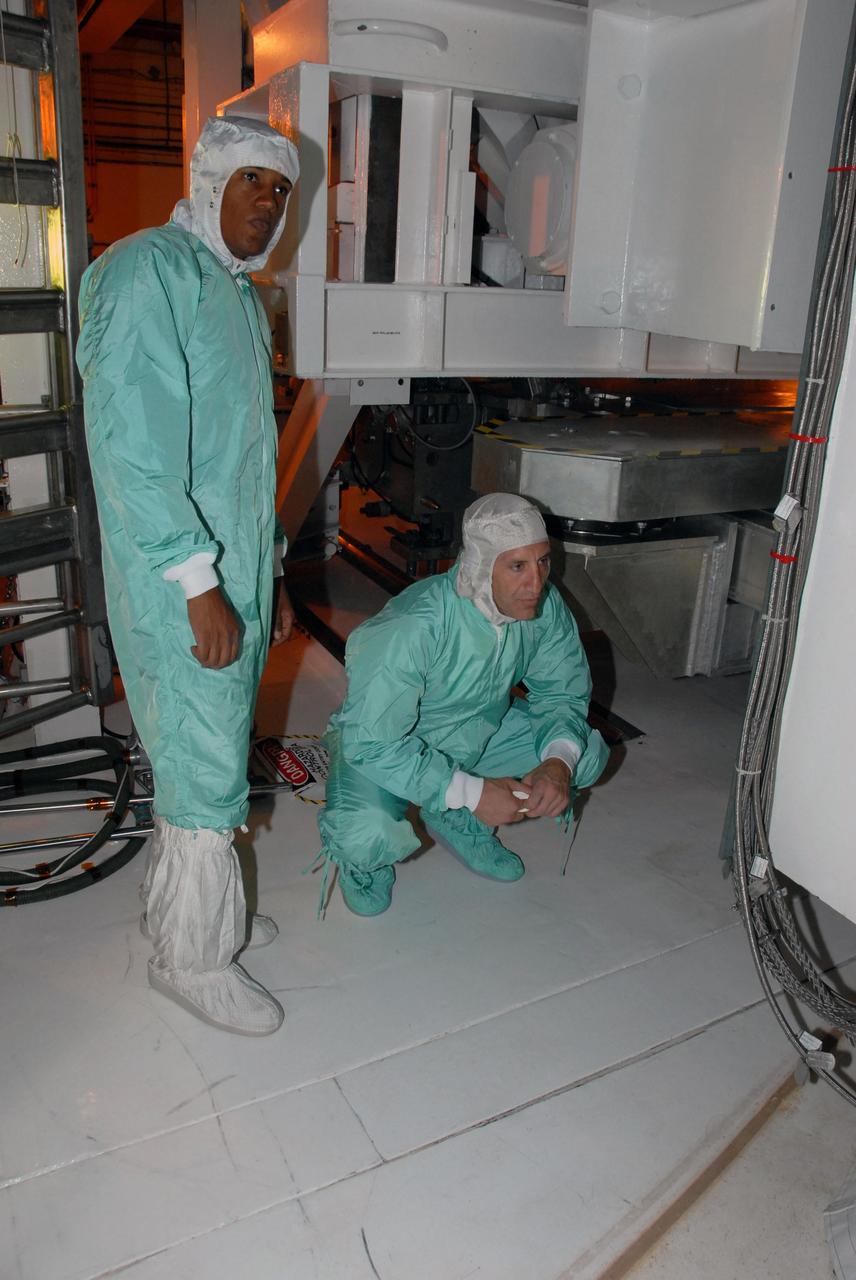 KENNEDY SPACE CENTER, Fla.  --  STS-118 crew members get a close look at the payloads installed in Space Shuttle Endeavour.  Seen here are Mission Specialist Alvin Drew (left) and Pilot Charlie Hobaugh.  The STS-118 crew has been at Kennedy for terminal countdown demonstration test activities that also include M-113 training, emergency egress training at the pad and a simulated launch countdown.  The mission is the 22nd flight to the International Space Station and Space Shuttle Endeavour will carry a payload including the S5 truss, a SPACEHAB module and external stowage platform 3. STS-118 is targeted for launch on Aug. 7.    Photo credit: NASA/George Shelton