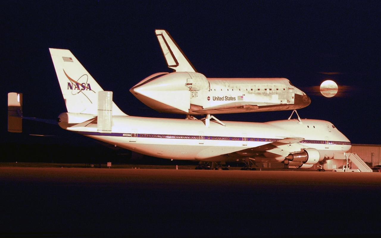 OFFUTT FIELD, NEB. -- The shuttle carrier aircraft, or SCA, and its piggyback passenger Atlantis are captured in the light of a full moon after landing at Offutt Field on the ferry flight from California to Florida.  Atlantis landed at Edwards Air Force Base in California to end mission STS-117. Touchdown was at 8:27 a.m. EDT. The SCA is a modified Boeing 747 jetliner.  The return to KSC began July 1 and took three days after stops across the country for fuel. The last stop was at Ft. Campbell in Kentucky. Weather conditions over the last leg postponed the return trip until July 3. Photo credit: NASA/Casey Wood