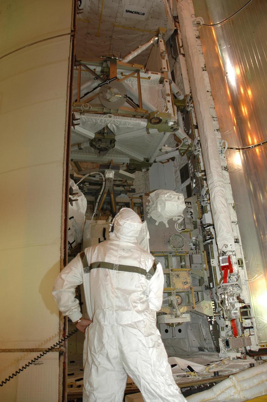 KENNEDY SPACE CENTER, FLA. — At Launch Pad 39A, a worker checks the progress of Endeavour's payload bay doors closing. The payload includes the S5 truss, the SPACEHAB module and external stowage platform 3. The mission is the 22nd flight to the International Space Station and is targeted for launch on Aug. 7. NASA/Charisse Nahser