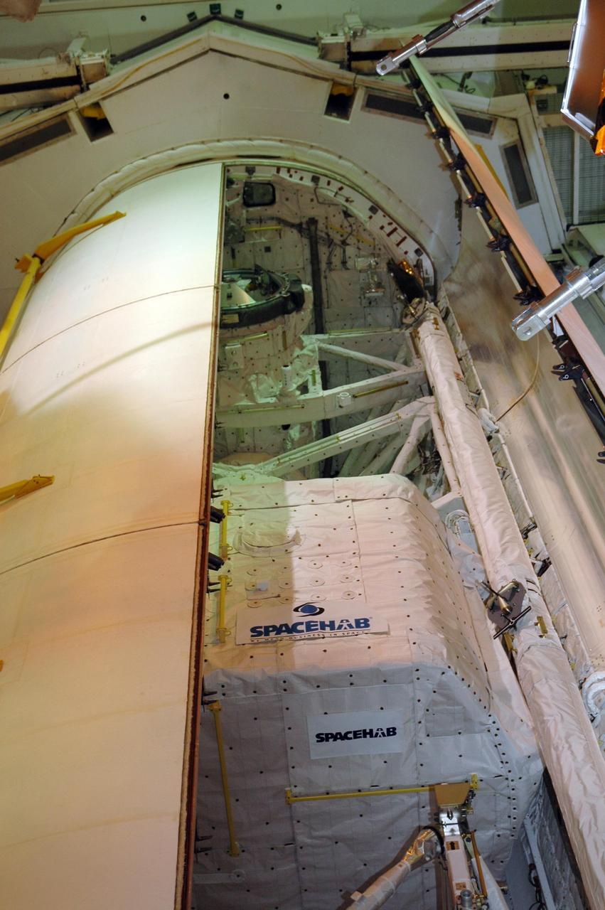 KENNEDY SPACE CENTER, FLA. — At Launch Pad 39A, the second payload bay door of Endeavour closes over the cargo inside. The payload includes the S5 truss, the SPACEHAB module and external stowage platform 3. The mission is the 22nd flight to the International Space Station and is targeted for launch on Aug. 7. NASA/Charisse Nahser