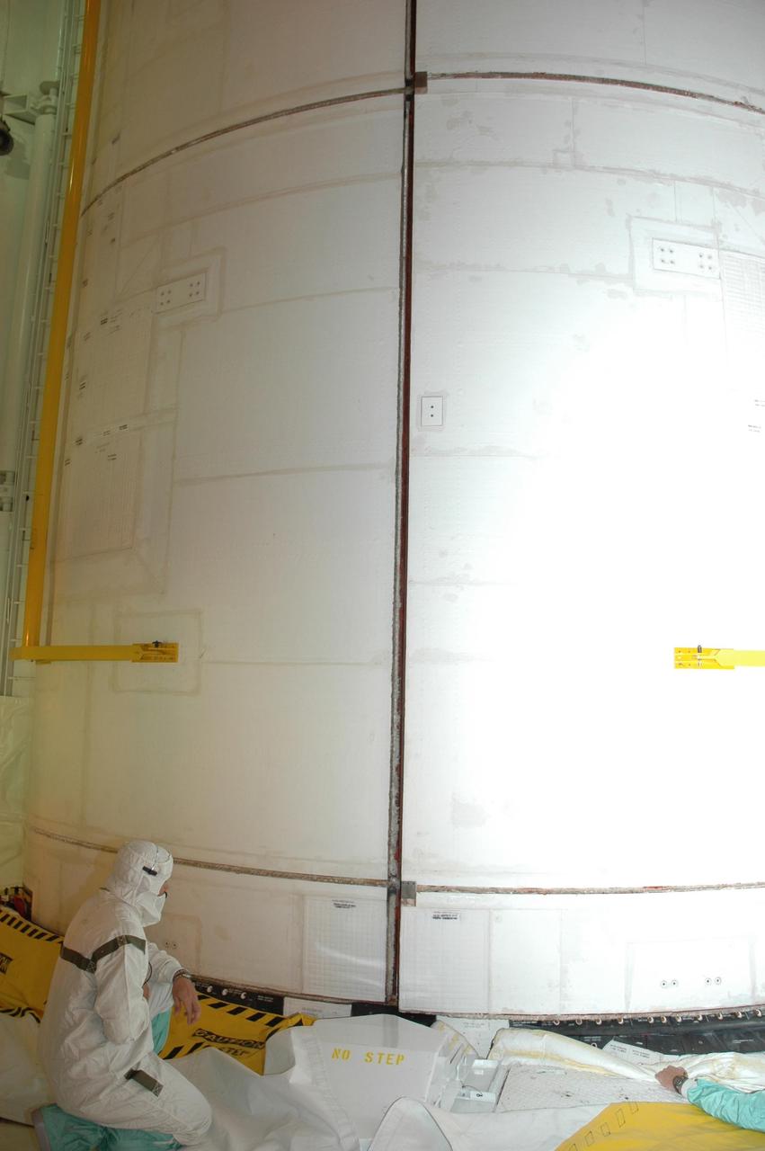 KENNEDY SPACE CENTER, FLA. — From inside the payload changeout room at Launch Pad 39A, workers check the closing of Endeavour's payload bay doors. The payload includes the S5 truss, the SPACEHAB module and external stowage platform 3. The mission is the 22nd flight to the International Space Station and is targeted for launch on Aug. 7. NASA/Charisse Nahser