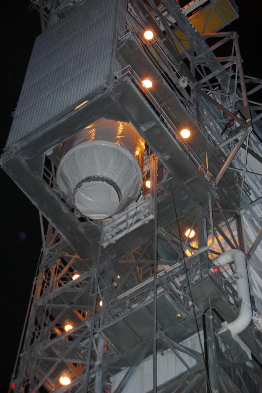 KENNEDY SPACE CENTER, FLA. — On Pad 17-B at Cape Canaveral Air Force Station, the Dawn spacecraft is lowered from the mobile service tower to the ground. Dawn is being returned to the Astrotech payload processing facility to await a new launch date. The launch opportunity extends from Sept. 7 to Oct. 15. Dawn is the ninth mission in NASA's Discovery Program. The spacecraft will be the first to orbit two planetary bodies, asteroid Vesta and dwarf planet Ceres, during a single mission. Vesta and Ceres lie in the asteroid belt between Mars and Jupiter. It is also NASA’s first purely scientific mission powered by three solar electric ion propulsion engines. NASA/George Shelton