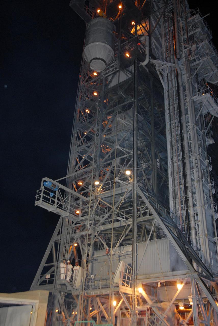 KENNEDY SPACE CENTER, FLA. —  On Pad 17-B at Cape Canaveral Air Force Station, the Dawn spacecraft is lowered from the mobile service tower to the ground.  Dawn is being returned to the Astrotech payload processing facility to await a new launch date.  The launch opportunity extends from Sept. 7 to Oct. 15. Dawn is the ninth mission in NASA's Discovery Program. The spacecraft will be the first to orbit two planetary bodies, asteroid Vesta and dwarf planet Ceres,  during a single mission. Vesta and Ceres lie in the asteroid belt between Mars and Jupiter. It is also NASA’s first purely scientific mission powered by three solar electric ion propulsion engines.   NASA/George Shelton