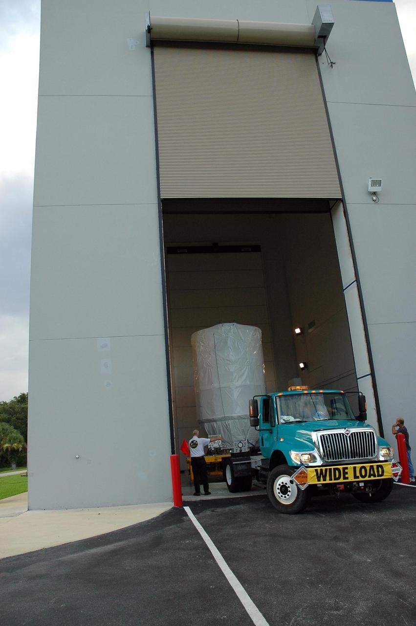 KENNEDY SPACE CENTER, FLA. — The Dawn spacecraft is moved inside the Astrotech payload processing facility. Dawn was returned from Launch Pad 17-B at Cape Canaveral Air Force Station to Astrotech to await a new launch date. The launch opportunity extends from Sept. 7 to Oct. 15. Dawn is the ninth mission in NASA's Discovery Program. The spacecraft will be the first to orbit two planetary bodies, asteroid Vesta and dwarf planet Ceres, during a single mission. Vesta and Ceres lie in the asteroid belt between Mars and Jupiter. It is also NASA’s first purely scientific mission powered by three solar electric ion propulsion engines. NASA/Charisse Nahser