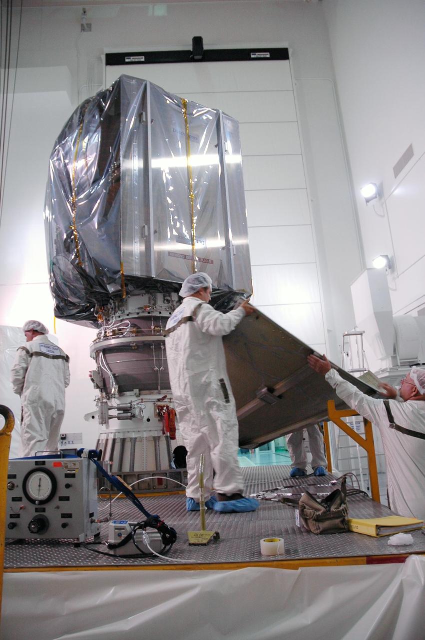 KENNEDY SPACE CENTER, FLA. —   At the Astrotech payload processing facility, workers remove the lower canister from around the Dawn spacecraft.  Dawn was returned from Launch Pad 17-B at Cape Canaveral Air Force Station to Astrotech to await a new launch date.  The launch opportunity extends from Sept. 7 to Oct. 15. Dawn is the ninth mission in NASA's Discovery Program. The spacecraft will be the first to orbit two planetary bodies, asteroid Vesta and dwarf planet Ceres,  during a single mission. Vesta and Ceres lie in the asteroid belt between Mars and Jupiter. It is also NASA’s first purely scientific mission powered by three solar electric ion propulsion engines.  NASA/Charisse Nahser