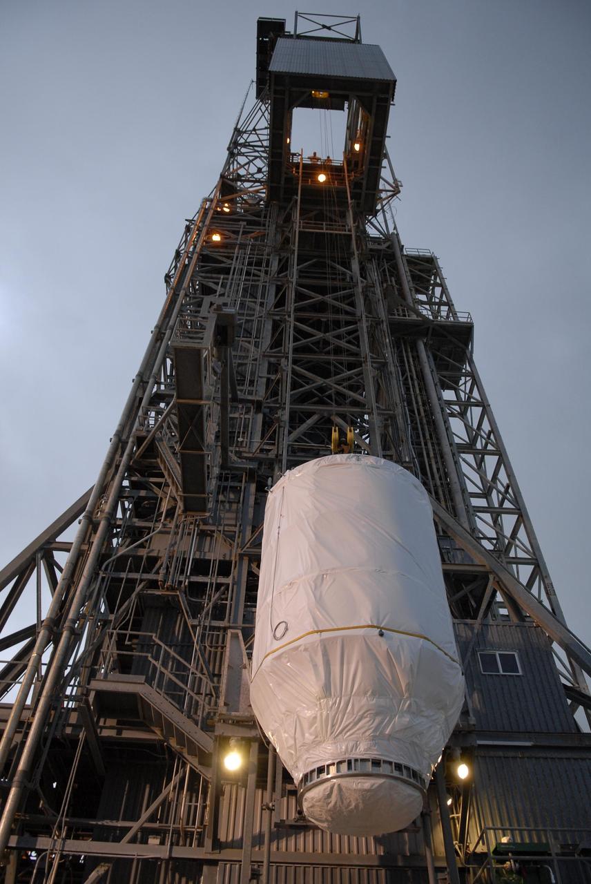 KENNEDY SPACE CENTER, FLA. — Attached to an overhead crane, the Phoenix Mars Lander is lifted up alongside the mobile service tower on Launch Pad 17-A at Cape Canaveral Air Force Station. Once inside the tower, the lander will be mated to the Delta II launch vehicle. Launch of NASA's Phoenix Mars Lander is scheduled for Aug. 3. There are two instantaneous launch times, 5:35:18 and 6:11:24 a.m. EDT. Phoenix will land in icy soils near the north polar permanent ice cap of Mars and explore the history of the water in these soils and any associated rocks, while monitoring polar climate. Landing on Mars is planned in May 2008 on arctic ground where a mission currently in orbit, Mars Odyssey, has detected high concentrations of ice just beneath the top layer of soil. NASA/George Shelton