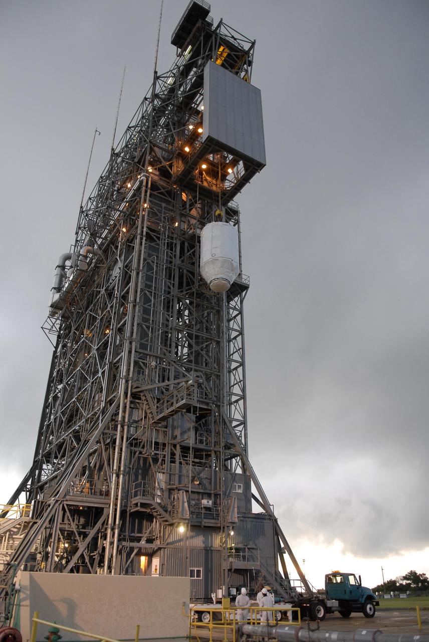 KENNEDY SPACE CENTER, FLA. — Attached to an overhead crane, the Phoenix Mars Lander nears the upper level of the mobile service tower on Launch Pad 17-A at Cape Canaveral Air Force Station. Once inside the tower, the lander will be mated to the Delta II launch vehicle. Launch of NASA's Phoenix Mars Lander is scheduled for Aug. 3. There are two instantaneous launch times, 5:35:18 and 6:11:24 a.m. EDT. Phoenix will land in icy soils near the north polar permanent ice cap of Mars and explore the history of the water in these soils and any associated rocks, while monitoring polar climate. Landing on Mars is planned in May 2008 on arctic ground where a mission currently in orbit, Mars Odyssey, has detected high concentrations of ice just beneath the top layer of soil. NASA/George Shelton