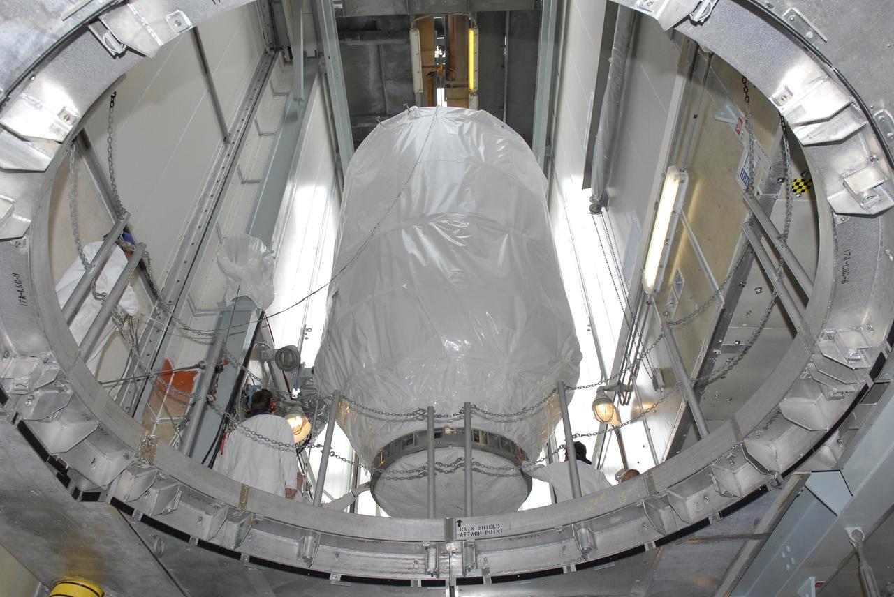 KENNEDY SPACE CENTER, FLA. — Viewed from below, the Phoenix Mars Lander moves toward the opening above the Delta II launch vehicle, to which it will be mated, inside the mobile service tower. Launch of NASA's Phoenix Mars Lander is scheduled for Aug. 3. There are two instantaneous launch times, 5:35:18 and 6:11:24 a.m. EDT. Phoenix will land in icy soils near the north polar permanent ice cap of Mars and explore the history of the water in these soils and any associated rocks, while monitoring polar climate. Landing on Mars is planned in May 2008 on arctic ground where a mission currently in orbit, Mars Odyssey, has detected high concentrations of ice just beneath the top layer of soil. NASA/George Shelton
