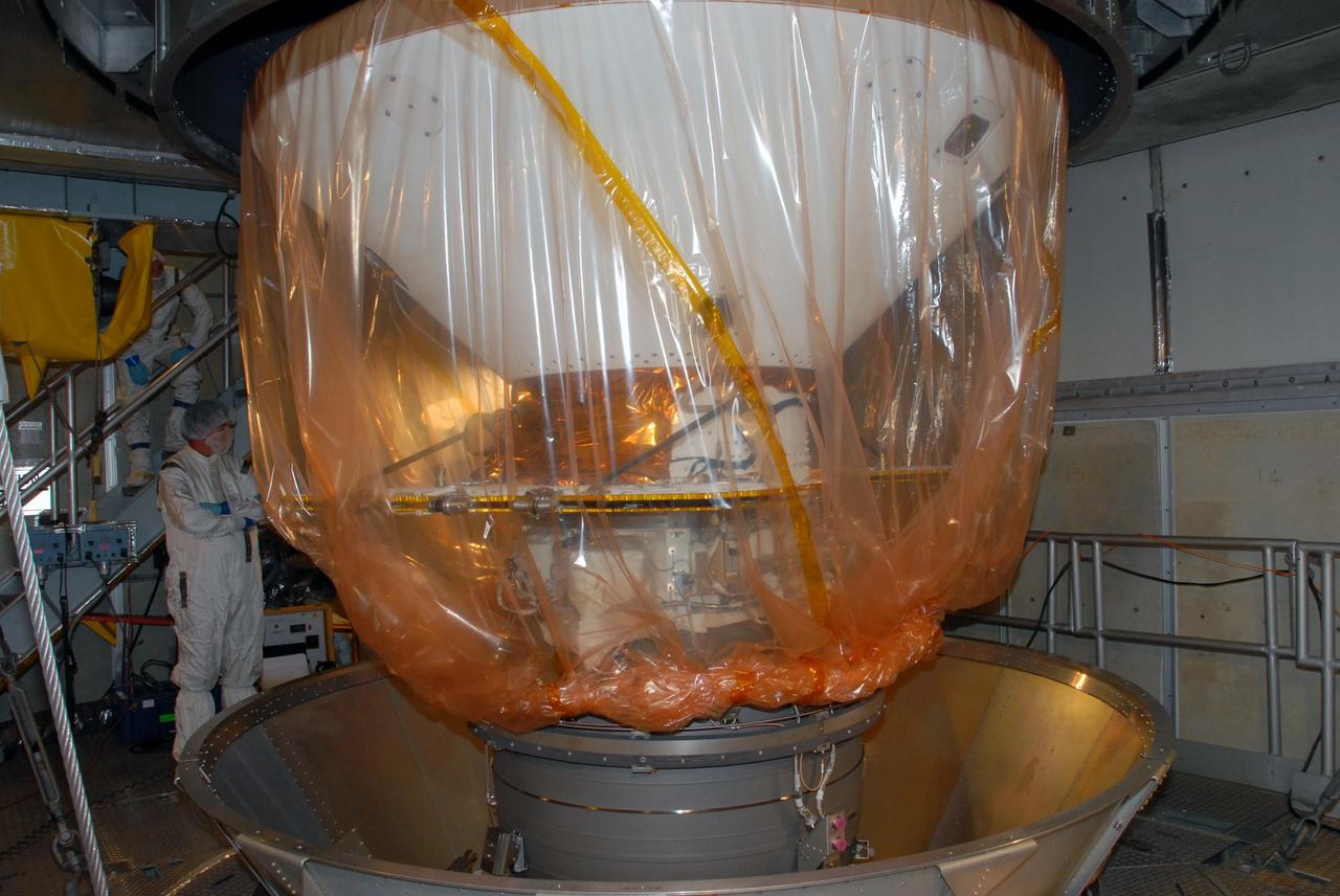KENNEDY SPACE CENTER, FLA. -- Inside the mobile service tower of Launch Pad 17-A at Cape Canaveral Air Force Station in Florida, workers remove the container from NASA's Phoenix Mars Lander. Launch of Phoenix is scheduled to launch on the Delta II launch vehicle no earlier than Aug. 3. Phoenix will land in icy soils near the north polar permanent ice cap of Mars and explore the history of the water in these soils and any associated rocks, while monitoring polar climate. Landing on Mars is planned in May 2008 on arctic ground where a mission currently in orbit, Mars Odyssey, detected high concentrations of ice just beneath the top layer of soil. NASA/George Shelton