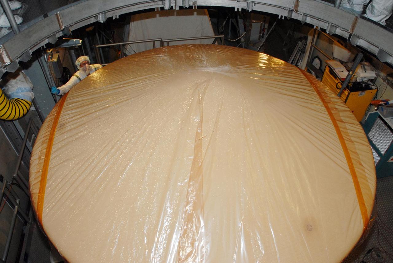 KENNEDY SPACE CENTER, FLA. -- Inside the mobile service tower of Launch Pad 17-A at Cape Canaveral Air Force Station in Florida, the top of NASA's Phoenix Mars Lander can be seen after workers removed the container lid. Phoenix is scheduled to launch on the Delta II launch vehicle no earlier than Aug. 3. Phoenix will land in icy soils near the north polar permanent ice cap of Mars and explore the history of the water in these soils and any associated rocks, while monitoring polar climate. Landing on Mars is planned in May 2008 on arctic ground where a mission currently in orbit, Mars Odyssey, detected high concentrations of ice just beneath the top layer of soil. NASA/George Shelton