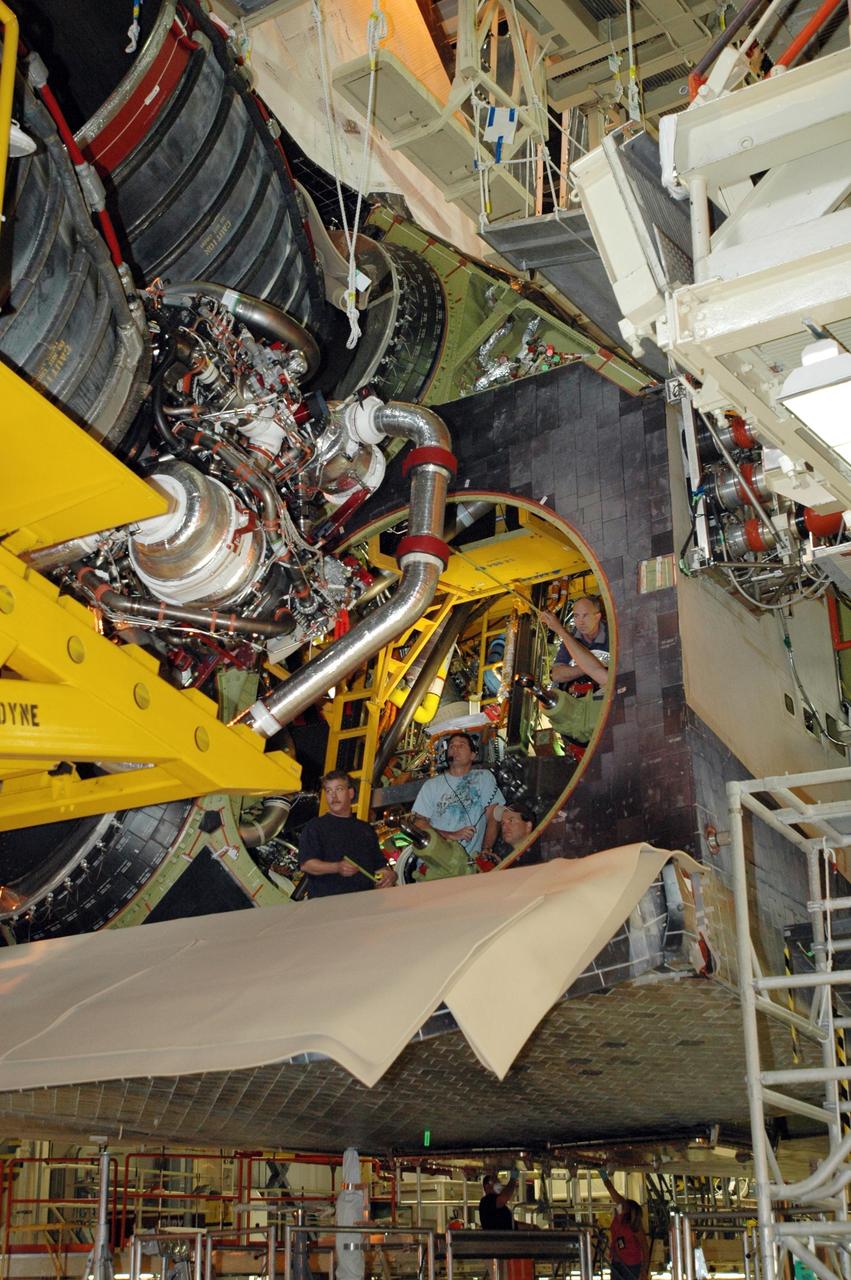 KENNEDY SPACE CENTER, FLA.  --   Inside Orbiter Processing Facility 3 at Kennedy Space Center, technicians prepare to install engine No. 3 to Discovery during processing for mission STS-120. Mission STS-120 will be the 23rd flight to the International Space Station. Space Shuttle Discovery will carry the U.S. Node 2. Launch is targeted for Oct. 20. NASA/Dimitri Gerondidakis