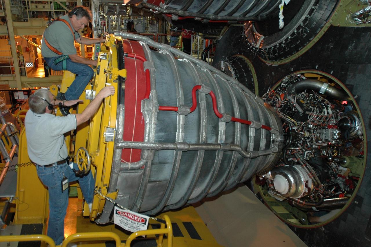 KENNEDY SPACE CENTER, FLA.  --   Inside Orbiter Processing Facility 3 at Kennedy Space Center, technicians move engine No. 3 toward the aft fuselage of Discovery for installation during processing for mission STS-120. Mission STS-120 will be the 23rd flight to the International Space Station. Space Shuttle Discovery will carry the U.S. Node 2. Launch is targeted for Oct. 20. NASA/Dimitri Gerondidakis