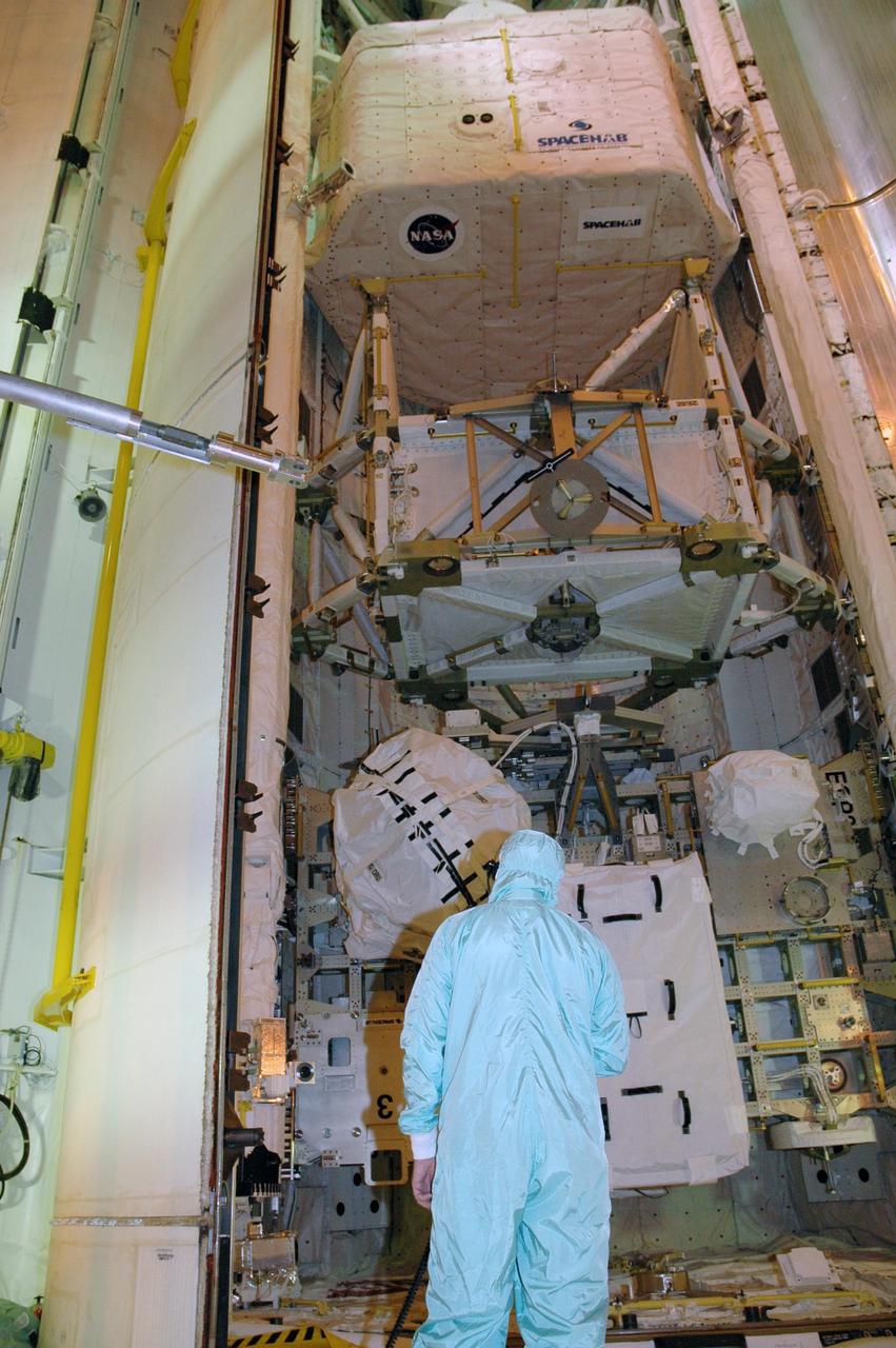 KENNEDY SPACE CENTER, FLA. -- On Launch Pad 39A, a worker checks the movement of one of Endeavour's payload bay doors as it closes. Seen in the photo are the cargo, from top, the SPACEHAB module, the S5 truss and the external stowage platform 3 with a control moment gyro at left. The payload bay doors were opened to allow for payload closeouts, including camera tests on the shuttle robotic arm and the extension, known as the orbiter boom sensor system. Endeavour is scheduled to launch Aug. 7 on mission STS-118, the 22nd flight to the International Space Station. NASA/Charisse Nahser