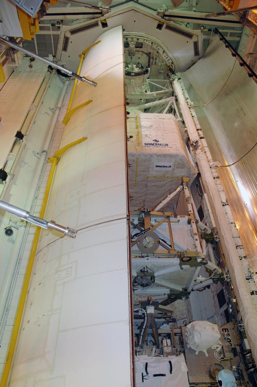 KENNEDY SPACE CENTER, FLA. -- On Launch Pad 39A, one of Endeavour's payload bay doors is closed. Part of the cargo inside can still be seen in the center: the SPACEHAB module and the S5 truss. The payload bay doors were opened to allow for payload closeouts, including camera tests on the shuttle robotic arm and the extension, known as the orbiter boom sensor system. Endeavour is scheduled to launch Aug. 7 on mission STS-118, the 22nd flight to the International Space Station. NASA/Charisse Nahser