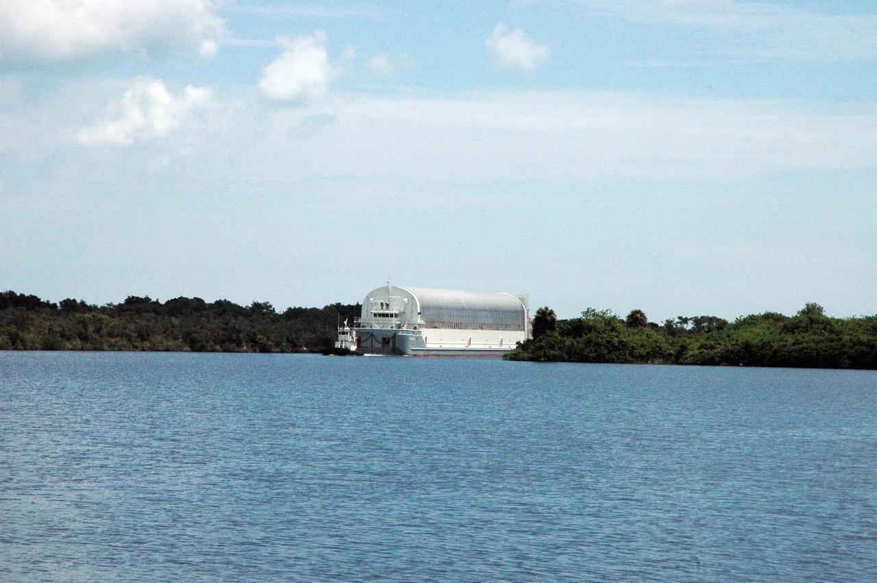KENNEDY SPACE CENTER, FLA. --      The Pegasus barge is towed into the Launch Complex 39 Area turn basin.  The cargo onboard is external tank No. 120, to be used for launching Space Shuttle Discovery on mission STS-120 in October.  The barge has carried the tank from the Michoud Assembly Facility near New Orleans, making the journey around the Florida peninsula in tow by the JA Bisso II  tugboat to Port Canaveral and Kennedy Space Center. After the tank is offloaded, it will be towed to the Vehicle Assembly Building for lifting into a checkout cell.   NASA/Amanda Diller