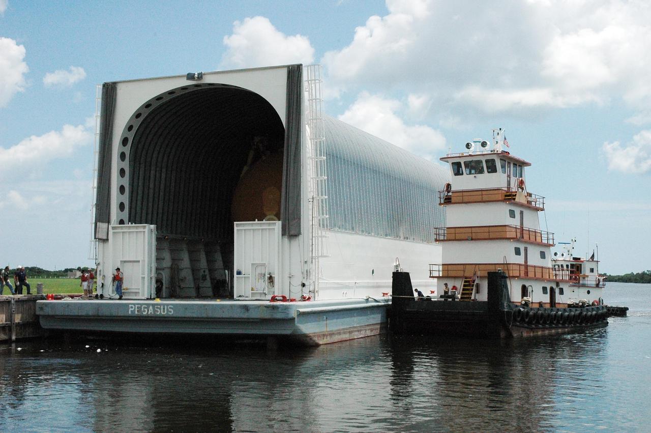 KENNEDY SPACE CENTER, FLA. --  In the Launch Complex 39 Area turn basin, the lead tugboat helps move the Pegasus barge closer to the dock so its cargo can be offloaded. The barge carries external tank No. 120, to be used for launching Space Shuttle Discovery on mission STS-120 in October.  The barge has carried the tank from the Michoud Assembly Facility near New Orleans, making the journey around the Florida peninsula in tow by the JA Bisso II  tugboat, to Port Canaveral and Kennedy Space Center. After the tank is offloaded, it will be towed to the Vehicle Assembly Building for lifting into a checkout cell.   NASA/Amanda Diller