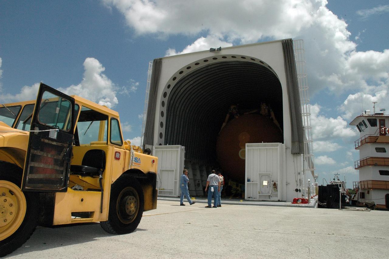 KENNEDY SPACE CENTER, FLA. --  The Pegasus barge is secure at the dock in the Launch Complex 39 Area turn basin after the last leg of its journey from Port Canaveral.  Inside Pegasus can be seen its cargo: external tank No. 120, to be used for launching Space Shuttle Discovery on mission STS-120 in October. The barge has carried the tank from the Michoud Assembly Facility near New Orleans, making the journey around the Florida peninsula in tow by the JA Bisso II  tugboat, to Port Canaveral and Kennedy Space Center. After the tank is offloaded, it will be towed to the Vehicle Assembly Building for lifting into a checkout cell.   NASA/Amanda Diller