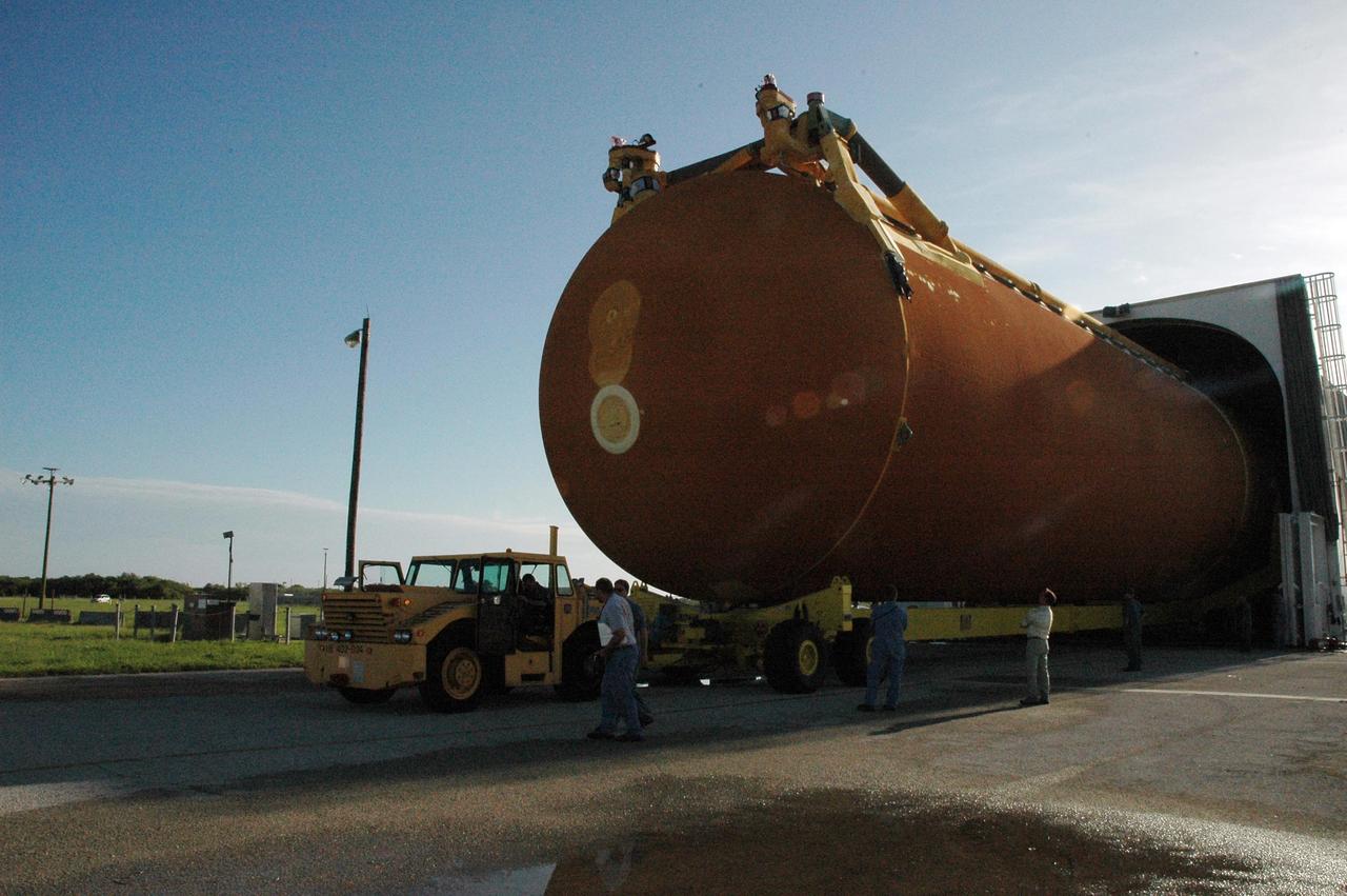KENNEDY SPACE CENTER, FLA. --  External tank No. 120 is offloaded from the Pegasus barge, which is docked at the Launch Complex 39 Area turn basin.  The tank will be moved to the Vehicle Assembly Building and lifted into a checkout cell.   The barge carried the tank from the Michoud Assembly Facility near New Orleans, making the journey around the Florida peninsula in tow by the JA Bisso II  tugboat, to Port Canaveral and Kennedy Space Center. ET-120 will be used for launching Space Shuttle Discovery on mission STS-120 in October.  NASA/Amanda Diller