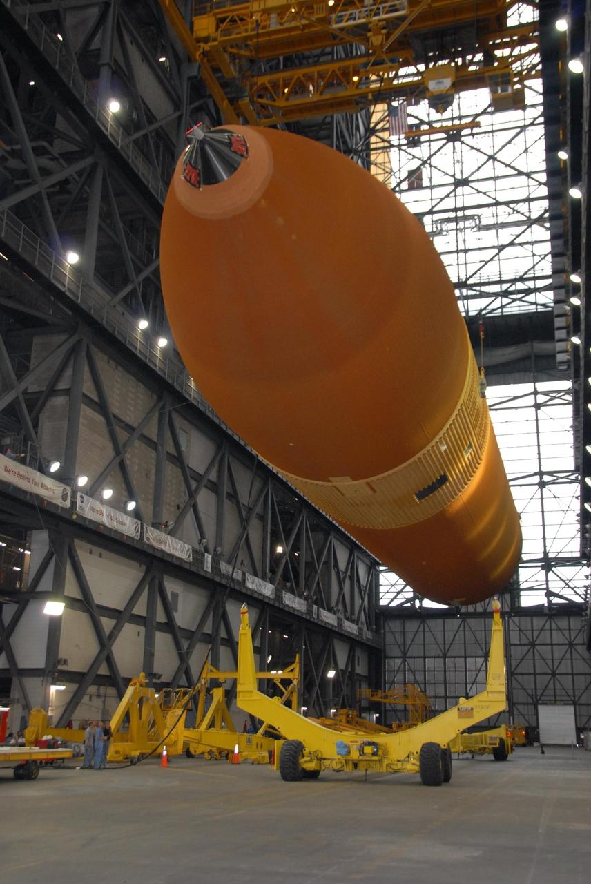KENNEDY SPACE CENTER, FLA. --  In the transfer aisle of the Vehicle Assembly Building at KSC, an overhead crane raises external tank No. 120 from its transporter.  The tank will be lifted into a checkout cell.  ET-120 will be used to launch Space Shuttle Discovery on mission STS-120 in October. The mission is the 23rd to the International Space Station and will launch an Italian-built, U.S. multi-port module known as Harmony for the station.  Christened after a school contest, Harmony will provide attachment points for European and Japanese laboratory modules. NASA/George Shelton