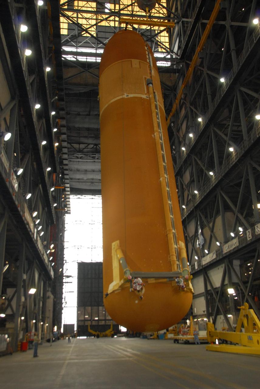 KENNEDY SPACE CENTER, FLA. --  In the transfer aisle of the Vehicle Assembly Building at KSC, an overhead crane raises external tank No. 120 to a vertical position.  The tank will next be lifted into a checkout cell.  ET-120 will be prepared for stacking with solid rocket boosters to launch Space Shuttle Discovery on mission STS-120 in October. The mission is the 23rd to the International Space Station and will launch an Italian-built, U.S. multi-port module known as Harmony for the station.  Christened after a school contest, Harmony will provide attachment points for European and Japanese laboratory modules. NASA/George Shelton