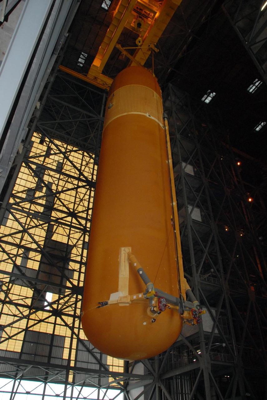 KENNEDY SPACE CENTER, FLA. --   In the Vehicle Assembly Building at KSC, a crane lifts external tank No. 120 into the upper regions.  The tank is being lifted for a move into a checkout cell.  The tank will be prepared for stacking with solid rocket boosters to launch Space Shuttle Discovery on mission STS-120 in October. The mission is the 23rd to the International Space Station and will launch an Italian-built, U.S. multi-port module known as Harmony for the station.  Christened after a school contest, Harmony will provide attachment points for European and Japanese laboratory modules. NASA/George Shelton
