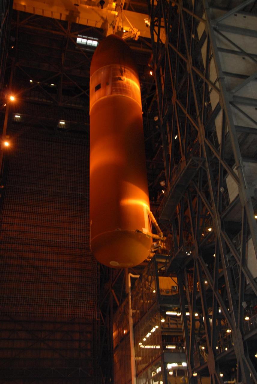 KENNEDY SPACE CENTER, FLA. --  In the Vehicle Assembly Building at KSC, a crane moves laterally to carry external tank No. 120 into a checkout cell.  The tank will be prepared for stacking with solid rocket boosters to launch Space Shuttle Discovery on mission STS-120 in October. The mission is the 23rd to the International Space Station and will launch an Italian-built, U.S. multi-port module known as Harmony for the station.  Christened after a school contest, Harmony will provide attachment points for European and Japanese laboratory modules. NASA/George Shelton