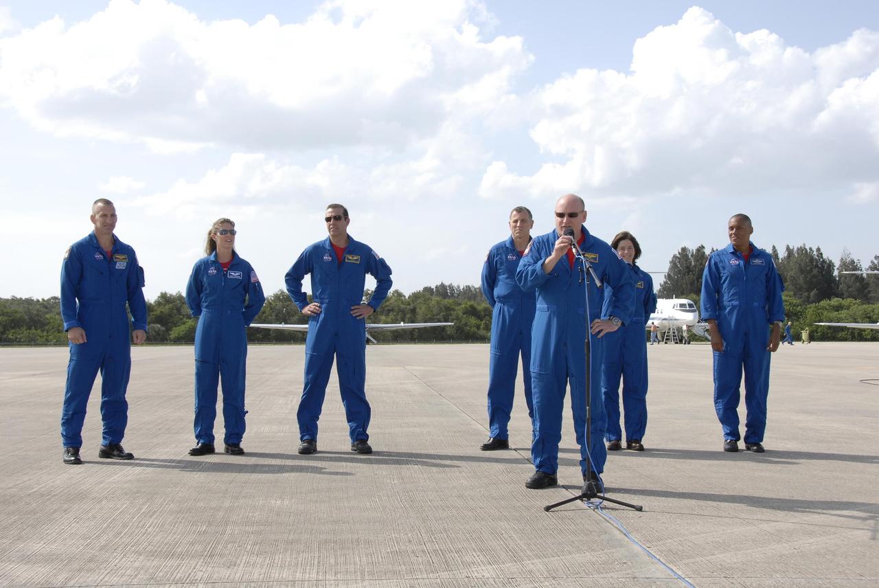 KENNEDY SPACE CENTER, FLA. --   The STS-118 crew arrives at Kennedy Space Center's Shuttle Landing Facility to prepare for launch on Aug. 8 aboard Space Shuttle Endeavour. Commander Scott Kelly addresses media representatives. From left, behind him are Pilot Charlie Hobaugh and Mission Specialists Tracy Caldwell, Rick Mastracchio, Dave Williams (with the Canadian Space Agency), Barbara Morgan (NASA's first educator astronaut) and Alvin Drew. Endeavour's STS-118 mission is the 22nd shuttle flight to the International Space Station. It will continue space station construction by delivering a third starboard truss segment, S5.  Other payloads include the SPACEHAB module, making its last voyage, and the external stowage platform 3 with a control moment gyroscope on it. The flight will include at least three spacewalks. The crew will also debut a new system that enables docked shuttles to draw electrical power from the station to extend visits to the outpost.  NASA/Kim Shiflett