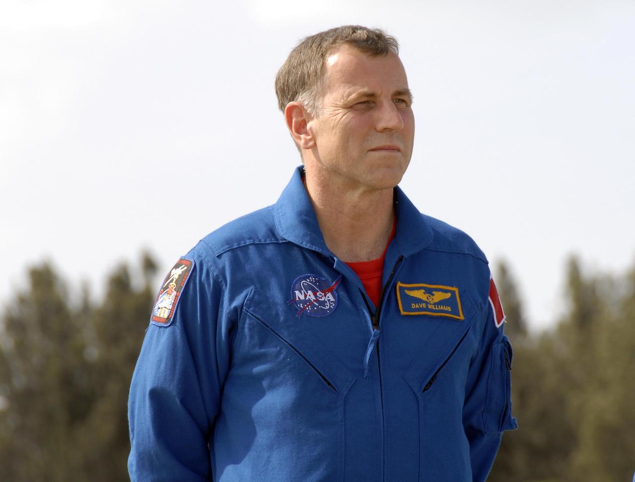 KENNEDY SPACE CENTER, FLA. --   The STS-118 crew arrives at Kennedy Space Center's Shuttle Landing Facility to prepare for launch on Aug. 8 aboard Space Shuttle Endeavour. Seen here is Mission Specialist Dave Williams, with the Canadian Space Agency. Endeavour's STS-118 mission is the 22nd shuttle flight to the International Space Station. It will continue space station construction by delivering a third starboard truss segment, S5.  Other payloads include the SPACEHAB module, making its last voyage, and the external stowage platform 3 with a control moment gyroscope on it. The flight will include at least three spacewalks. The crew will also debut a new system that enables docked shuttles to draw electrical power from the station to extend visits to the outpost. Photo credit:  NASA/Kim Shiflett