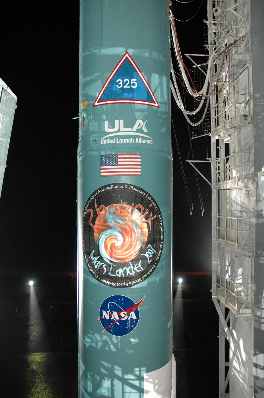 KENNEDY SPACE CENTER, FLA. -- The Delta II 7925 rocket is revealed as the mobile service tower, or gantry, is retracted on Launch Pad 17A at Cape Canaveral Air Force Station.  Equipped with three stages and nine strap-on solid rocket motors, the Delta II rocket packs plenty of punch for sending the Phoenix spacecraft on its way toward Mars. Launch is targeted for Aug. 4 during one of two opportunities for liftoff: 5:26 or 6:02 a.m. EDT. Phoenix will land in icy soils near the north polar, permanent ice cap of Mars and explore the history of the water in these soils and any associated rocks, while monitoring polar climate. Landing on Mars is planned in May 2008 on arctic ground where a mission currently in orbit, Mars Odyssey, has detected high concentrations of ice just beneath the top layer of soil.   Photo credit: NASA/Jim Grossmann