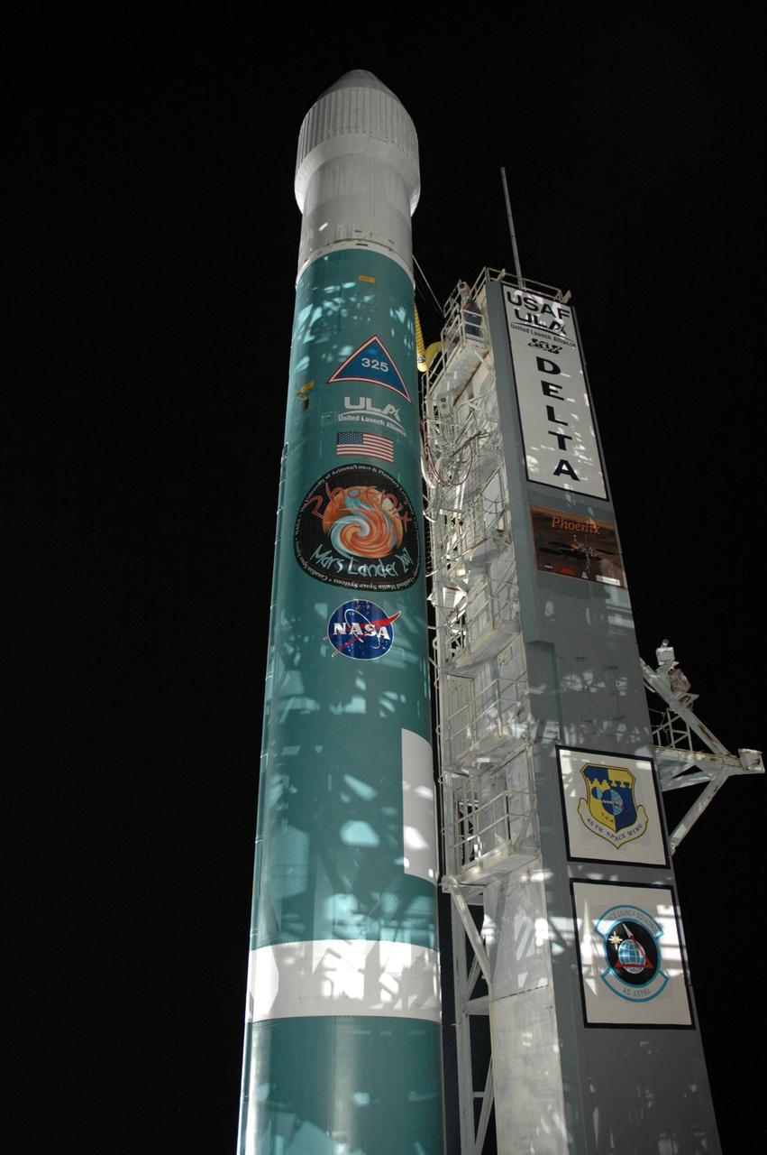 KENNEDY SPACE CENTER, FLA. -- The Delta II 7925 rocket stands ready for launch following rollback of the mobile service tower, or gantry, on Launch Pad 17A at Cape Canaveral Air Force Station. Equipped with three stages and nine strap-on solid rocket motors, the Delta II rocket packs plenty of punch for sending the Phoenix spacecraft on its way toward Mars. Launch is targeted for Aug. 4 during one of two opportunities for liftoff: 5:26 or 6:02 a.m. EDT. Phoenix will land in icy soils near the north polar, permanent ice cap of Mars and explore the history of the water in these soils and any associated rocks, while monitoring polar climate. Landing on Mars is planned in May 2008 on arctic ground where a mission currently in orbit, Mars Odyssey, has detected high concentrations of ice just beneath the top layer of soil. Photo credit: NASA/Jim Grossmann