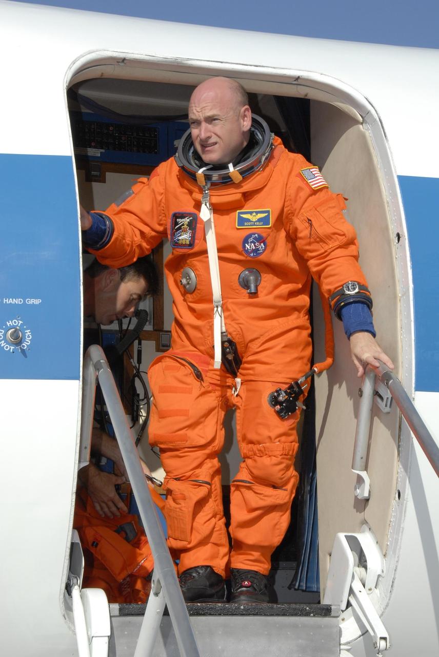 KENNEDY SPACE CENTER, FLA. - STS-118 Commander Scott Kelly disembarks from the shuttle training aircraft, or STA, at the Shuttle Landing Facility, Kennedy Space Center's airstrip. He and STS-118 Pilot Charlie Hobaugh were at the facility to practice landings for their upcoming mission. The STA is a Grumman American Aviation-built Gulf Stream II jet that was modified to simulate an orbiter's cockpit, motion and visual cues, and handling qualities. In flight, the STA duplicates the orbiter's atmospheric descent trajectory from approximately 35,000 feet altitude to landing on a runway.  Endeavour's STS-118 mission is the 22nd shuttle flight to the International Space Station. It will continue space station construction by delivering a third starboard truss segment, S5. Other payloads include the SPACEHAB module, making its last voyage, and the external stowage platform 3 with a control moment gyroscope on it. The flight will include at least three spacewalks. The crew will also debut a new system that enables docked shuttles to draw electrical power from the station to extend visits to the outpost. Launch is set for Aug. 8 at 6:36 p.m. EDT.  NASA/Kim Shiflett