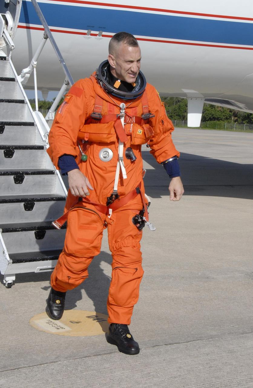 KENNEDY SPACE CENTER, FLA. - STS-118 Pilot Charlie Hobaugh disembarks from the shuttle training aircraft, or STA, at the Shuttle Landing Facility, Kennedy Space Center's airstrip. He and STS-118 Commander Scott Kelly were at the facility to practice landings for their upcoming mission. The STA is a Grumman American Aviation-built Gulf Stream II jet that was modified to simulate an orbiter's cockpit, motion and visual cues, and handling qualities. In flight, the STA duplicates the orbiter's atmospheric descent trajectory from approximately 35,000 feet altitude to landing on a runway.  Endeavour's STS-118 mission is the 22nd shuttle flight to the International Space Station. It will continue space station construction by delivering a third starboard truss segment, S5. Other payloads include the SPACEHAB module, making its last voyage, and the external stowage platform 3 with a control moment gyroscope on it. The flight will include at least three spacewalks. The crew will also debut a new system that enables docked shuttles to draw electrical power from the station to extend visits to the outpost. Launch is set for Aug. 8 at 6:36 p.m. EDT.  Photo credit: NASA/Kim Shiflett