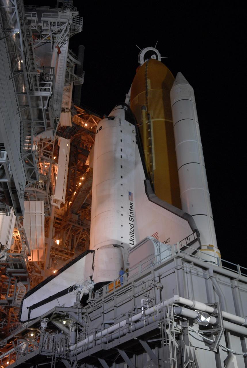 KENNEDY SPACE CENTER, FLA. - Space Shuttle Endeavour is revealed on Launch Pad 39A after rollback of the rotating service structure, or RSS, at left of the pad. Rollback started at 9 p.m. EDT Aug. 7 and was complete at 10:40 p.m. Beneath the shuttle is the mobile launcher platform. The RSS provides protected access to the orbiter for changeout and servicing of payloads at the pad. Rollback of the pad's RSS is one of the milestones in preparation for the launch of mission STS-118 at 6:36 p.m. EDT on Aug. 8. Space Shuttle Endeavour's STS-118 mission is the 22nd shuttle flight to the International Space Station. It will continue space station construction by delivering a third starboard truss segment, S5, and other payloads such as the SPACEHAB module and the external stowage platform 3. Photo credit: NASA/Kim Shiflett