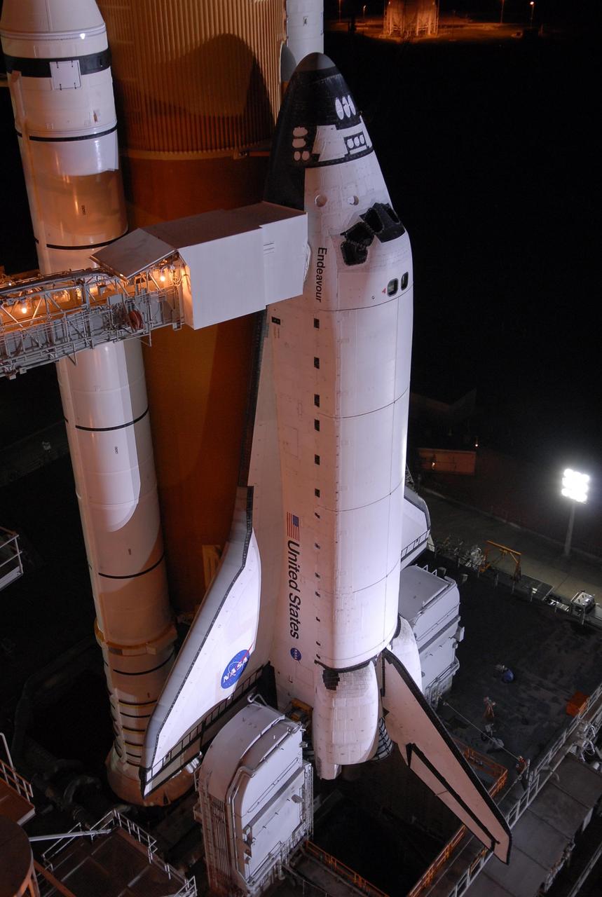 KENNEDY SPACE CENTER, FLA. - The orbiter access arm is positioned against Space Shuttle Endeavour after rollback of the rotating service structure, or RSS, on Launch Pad 39A.  At the end of the arm is a clean room from which the astronauts enter the crew compartment of the orbiter for launch. Rollback started at 9 p.m. EDT Aug. 7 and was complete at 10:40 p.m. The RSS provides protected access to the orbiter for changeout and servicing of payloads at the pad. Rollback of the pad's RSS is one of the milestones in preparation for the launch of mission STS-118 at 6:36 p.m. EDT on Aug. 8. Space Shuttle Endeavour's STS-118 mission is the 22nd shuttle flight to the International Space Station. It will continue space station construction by delivering a third starboard truss segment, S5, and other payloads such as the SPACEHAB module and the external stowage platform 3.  Photo credit: NASA/Kim Shiflett