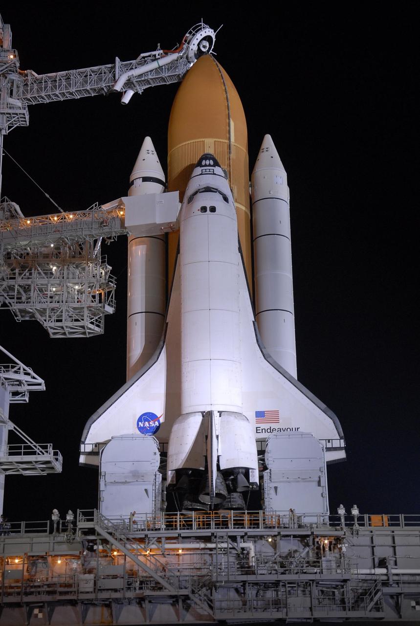 KENNEDY SPACE CENTER, FLA. - The orbiter access arm is positioned against Space Shuttle Endeavour after rollback of the rotating service structure, or RSS, on Launch Pad 39A.  At the end of the arm is a clean room from which the astronauts enter the crew compartment of the orbiter for launch. Rollback started at 9 p.m. EDT Aug. 7 and was complete at 10:40 p.m. The RSS provides protected access to the orbiter for changeout and servicing of payloads at the pad. Rollback of the pad's RSS is one of the milestones in preparation for the launch of mission STS-118 at 6:36 p.m. EDT on Aug. 8. Space Shuttle Endeavour's STS-118 mission is the 22nd shuttle flight to the International Space Station. It will continue space station construction by delivering a third starboard truss segment, S5, and other payloads such as the SPACEHAB module and the external stowage platform 3.  Photo credit: NASA/Kim Shiflett