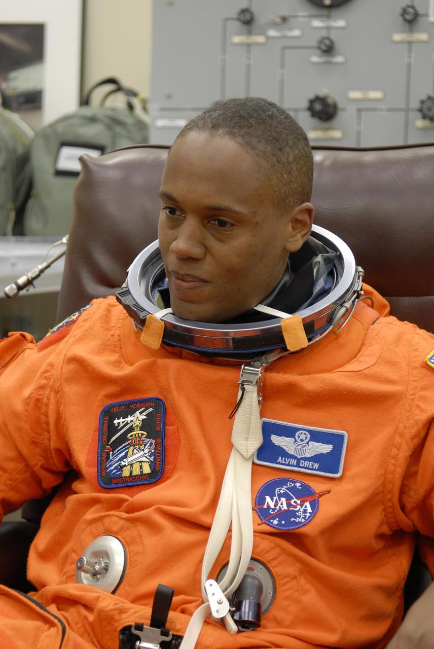 KENNEDY SPACE CENTER, FLA. -- In the Operations and Checkout Building, STS-118 Mission Specialist Alvin Drew reflects on the auspicious moment of suiting up for launch.  Drew is making his first spaceflight when Space Shuttle Endeavour launches on mission STS-120.   Space Shuttle Endeavour's STS-118 mission is the 22nd shuttle flight to the International Space Station. It will continue space station construction by delivering a third starboard truss segment, S5, and other payloads such as the SPACEHAB module and the external stowage platform 3.  The 11-day mission may be extended to as many as 14 depending on the test of the Station-to-Shuttle Power Transfer System that will allow the docked shuttle to draw electrical power from the station and extend its visits to the orbiting lab.  NASA/Kim Shiflett