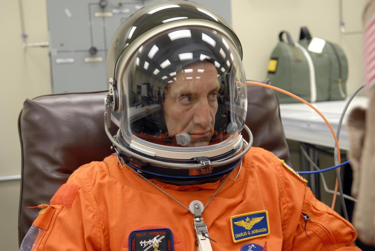 KENNEDY SPACE CENTER, FLA. --  In the Operations and Checkout Building, STS-118 Pilot Charlie Hobaugh is ready after suitup to head for the launch pad  and board Space Shuttle Endeavour.  The STS-118 mission is the 22nd shuttle flight to the International Space Station. It will continue space station construction by delivering a third starboard truss segment, S5, and other payloads such as the SPACEHAB module and the external stowage platform 3.  The 11-day mission may be extended to as many as 14 depending on the test of the Station-to-Shuttle Power Transfer System that will allow the docked shuttle to draw electrical power from the station and extend its visits to the orbiting lab.  NASA/Kim Shiflett