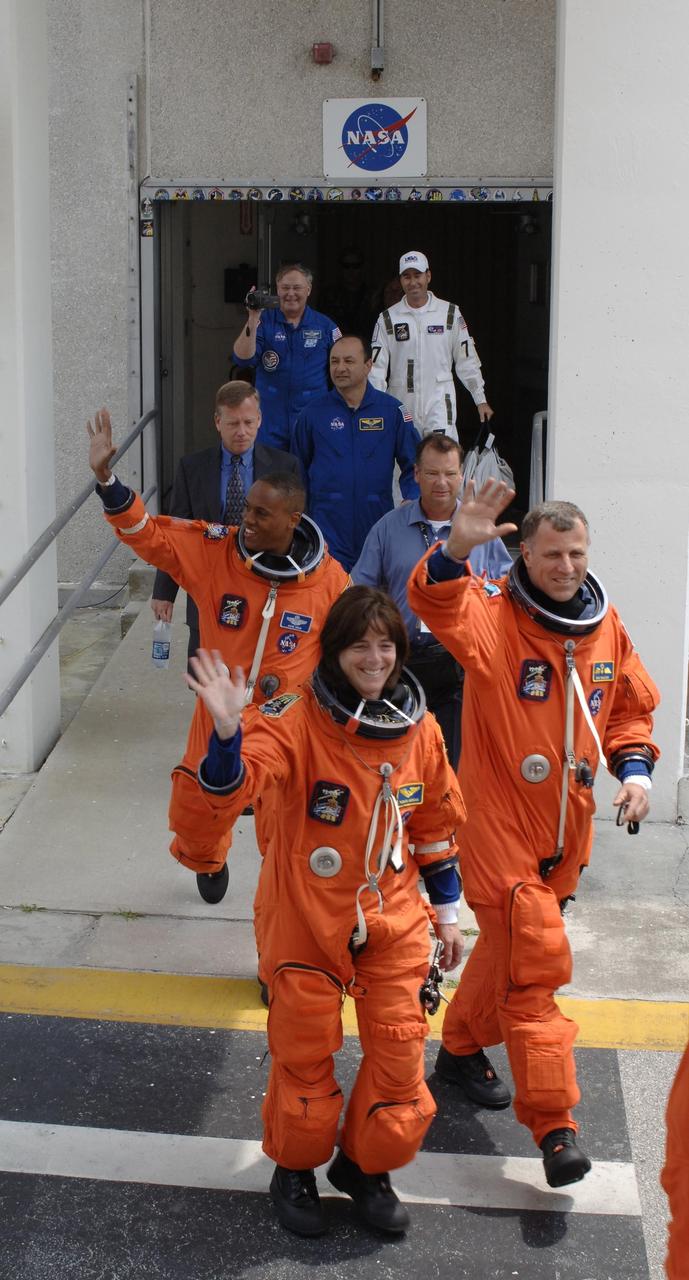 KENNEDY SPACE CENTER, FLA. --  The STS-118 crew strides out of the Operations and Checkout Building eager to get to Launch Pad 39A for launch of Space Shuttle Endeavour at 6:36 p.m. EDT.  Seen here are (left to right) Mission Specialists Alvin Drew, teacher-turned-astronaut Barbara R. Morgan, and Dave Williams, who represents the Canadian Space Agency.  The STS-118 mission is the 22nd shuttle flight to the International Space Station. It will continue space station construction by delivering a third starboard truss segment, S5, and other payloads such as the SPACEHAB module and the external stowage platform 3.  The 11-day mission may be extended to as many as 14 depending on the test of the Station-to-Shuttle Power Transfer System that will allow the docked shuttle to draw electrical power from the station and extend its visits to the orbiting lab.  NASA/Kim Shiflett