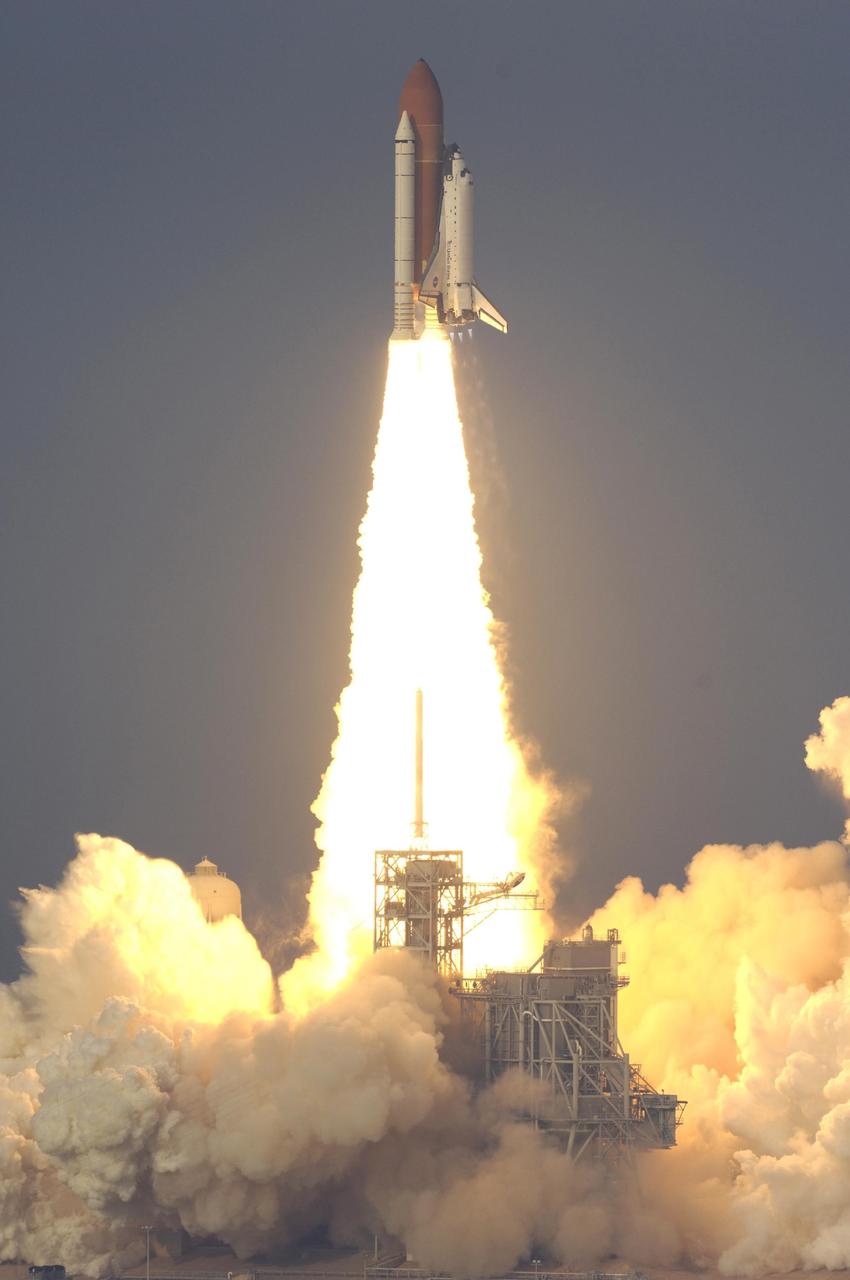 KENNEDY SPACE CENTER, FLA. -- Emerging from the billows of smoke below, Space Shuttle Endeavour clears the lightning mast on the fixed service structure below to begin its journey on mission STS-118.  Liftoff from Launch Pad 39A was on time at 6:36 p.m. EDT.  The mission is the 22nd shuttle flight to the International Space Station. It will continue space station construction by delivering a third starboard truss segment, S5, and other payloads such as the SPACEHAB module and the external stowage platform 3.  The 11-day mission may be extended to as many as 14 depending on the test of the Station-to-Shuttle Power Transfer System that will allow the docked shuttle to draw electrical power from the station and extend its visits to the orbiting lab.  Photo courtesy of Nikon/Scott Andrews