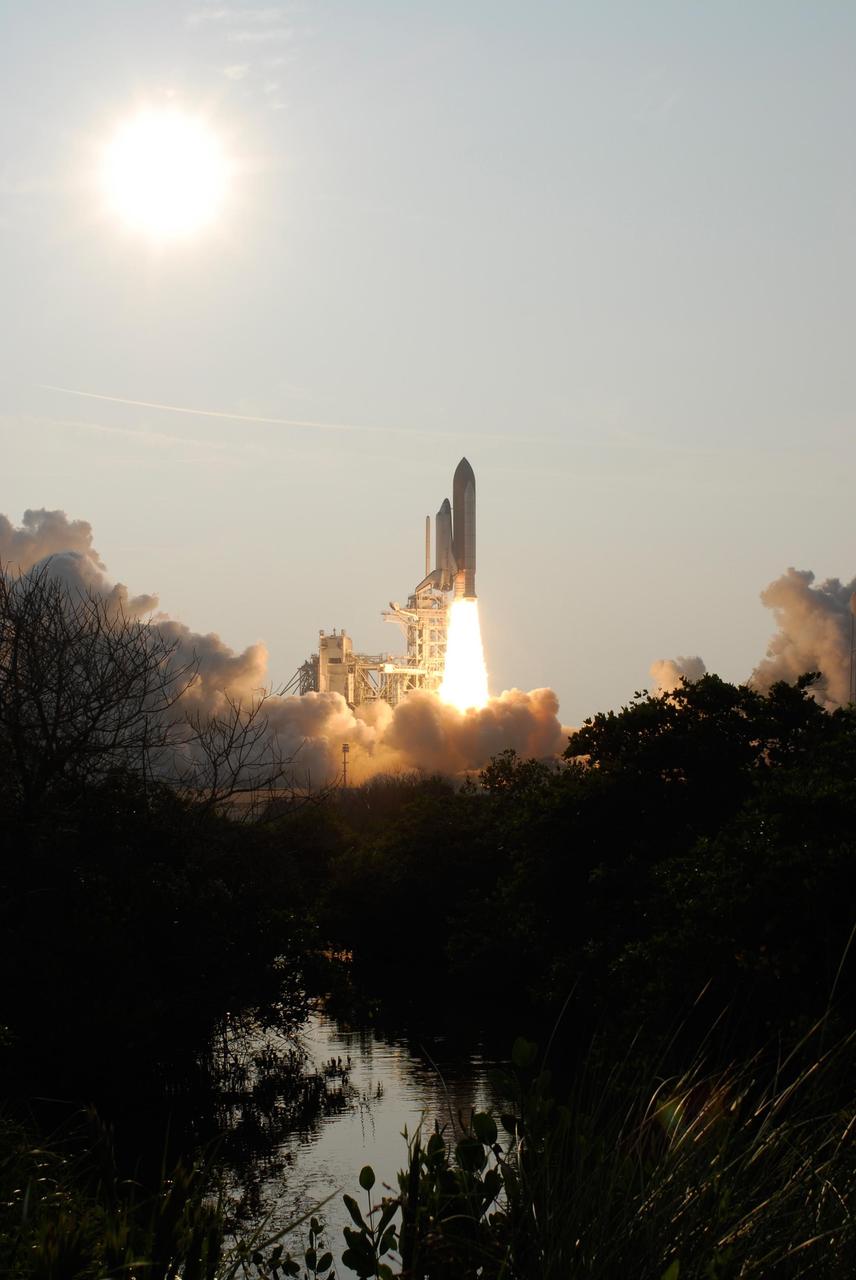 KENNEDY SPACE CENTER, FLA. --  Deep shadows are broken by the fiery launch of Space Shuttle Endeavour as it leaps free of Launch Pad 39A to begin mission STS-118.  Liftoff  was on time at 6:36 p.m. EDT.  The mission is the 22nd shuttle flight to the International Space Station. It will continue space station construction by delivering a third starboard truss segment, S5, and other payloads such as the SPACEHAB module and the external stowage platform 3.  The 11-day mission may be extended to as many as 14 depending on the test of the Station-to-Shuttle Power Transfer System that will allow the docked shuttle to draw electrical power from the station and extend its visits to the orbiting lab.  Photo credit: NASA/Sandra Joseph, Tony Gray, Robert Murray