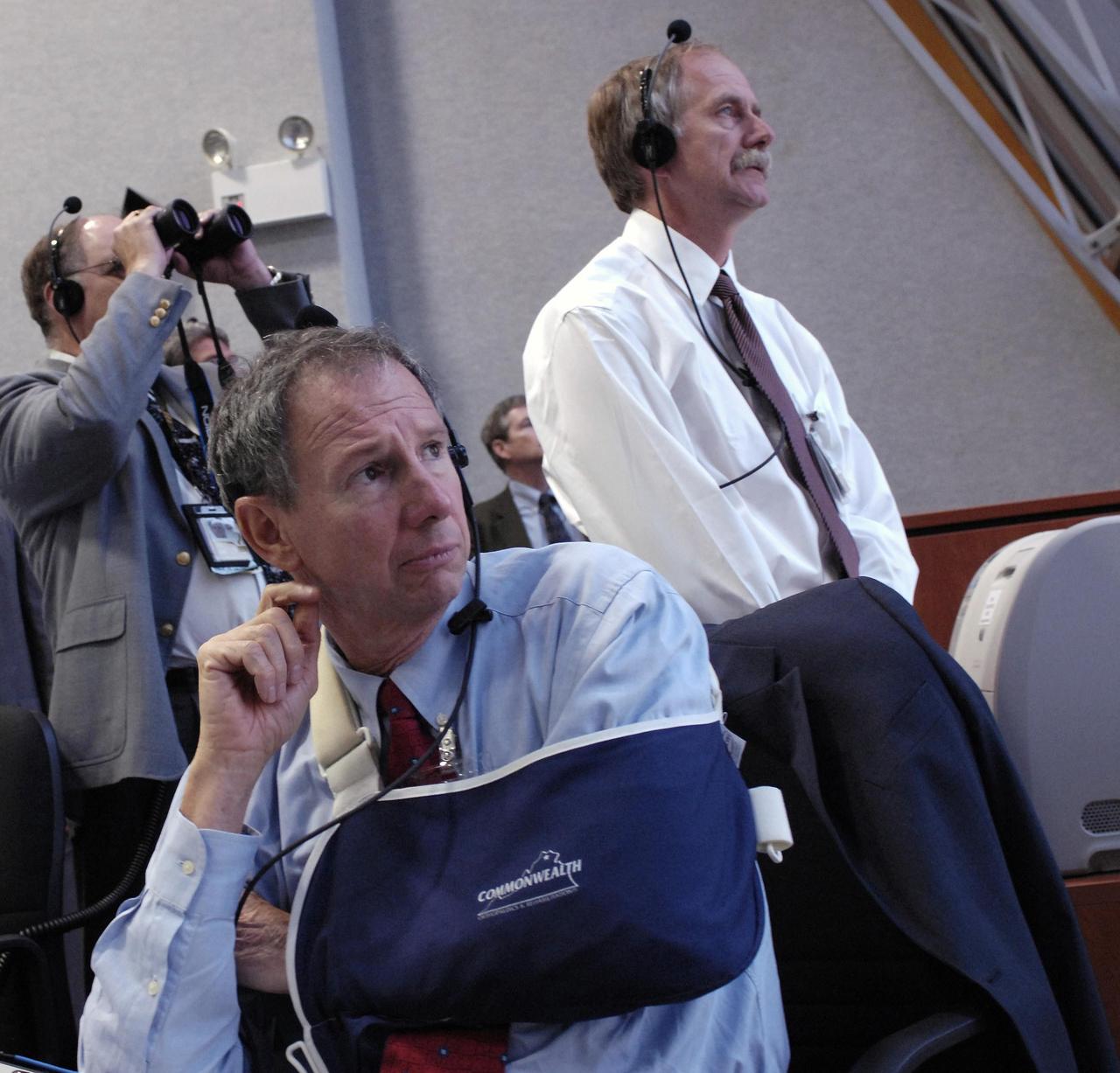 KENNEDY SPACE CENTER, FLA. --  NASA Administrator Mike Griffin (front) and Associate Administrator for NASA Space Operations Mission William Gerstenmaier (right) watch the launch of Space Shuttle Endeavour on mission STS-118 from the Launch Control Center at Kennedy Space Center.  The liftoff from Launch Pad 39A was on time at 6:36 p.m. EDT.  The mission is the 22nd shuttle flight to the International Space Station. It will continue space station construction by delivering a third starboard truss segment, S5, and other payloads such as the SPACEHAB module and the external stowage platform 3.  The 11-day mission may be extended to as many as 14 depending on the test of the Station-to-Shuttle Power Transfer System that will allow the docked shuttle to draw electrical power from the station and extend its visits to the orbiting lab.  Photo credit: NASA/Bill Ingalls