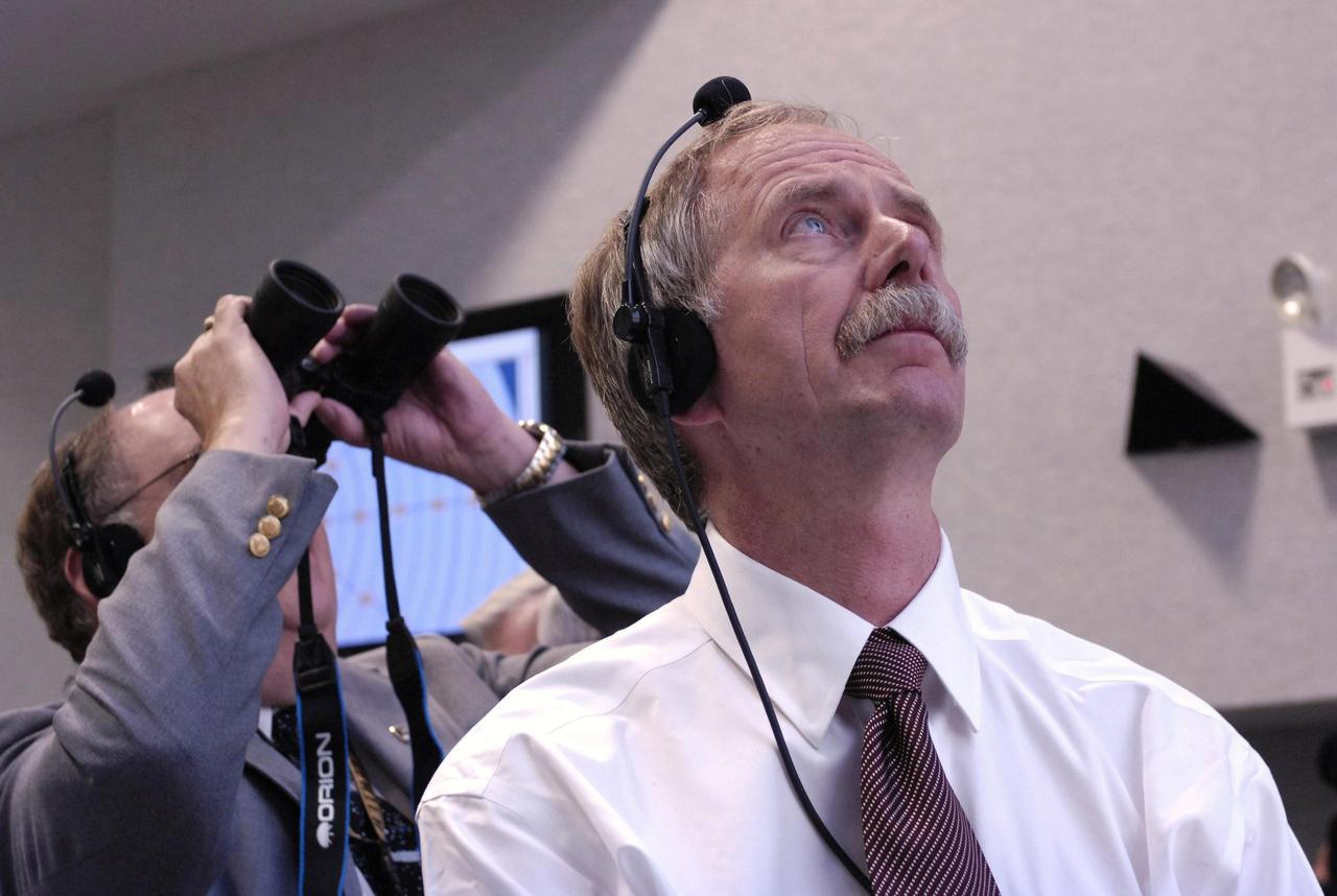 KENNEDY SPACE CENTER, FLA. -- Associate Administrator for NASA Space Operations Mission William Gerstenmaier (right) watches  the launch of Space Shuttle Endeavour on mission STS-118 from the Launch Control Center at Kennedy Space Center.  The liftoff from Launch Pad 39A was on time at 6:36 p.m. EDT.  The mission is the 22nd shuttle flight to the International Space Station. It will continue space station construction by delivering a third starboard truss segment, S5, and other payloads such as the SPACEHAB module and the external stowage platform 3.  The 11-day mission may be extended to as many as 14 depending on the test of the Station-to-Shuttle Power Transfer System that will allow the docked shuttle to draw electrical power from the station and extend its visits to the orbiting lab.  Photo credit: NASA/Bill Ingalls