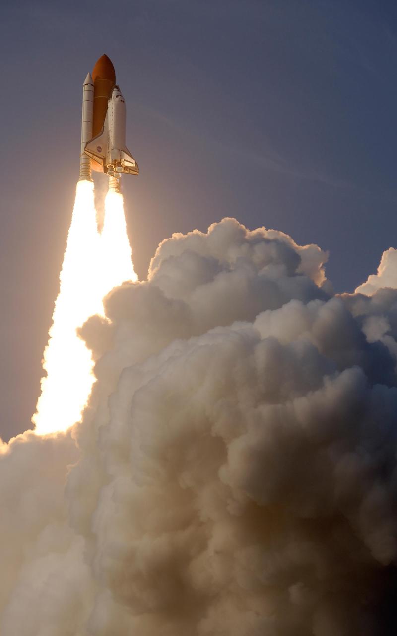 KENNEDY SPACE CENTER, FLA. -- Space Shuttle Endeavour breaks free from the clouds of smoke after liftoff from Launch Pad 39A on mission STS-118. The liftoff was on time at 6:36 p.m. EDT.  The mission is the 22nd shuttle flight to the International Space Station. It will continue space station construction by delivering a third starboard truss segment, S5, and other payloads such as the SPACEHAB module and the external stowage platform 3.  The 11-day mission may be extended to as many as 14 depending on the test of the Station-to-Shuttle Power Transfer System that will allow the docked shuttle to draw electrical power from the station and extend its visits to the orbiting lab.  Photo courtesy of Nikon/Scott Andrews