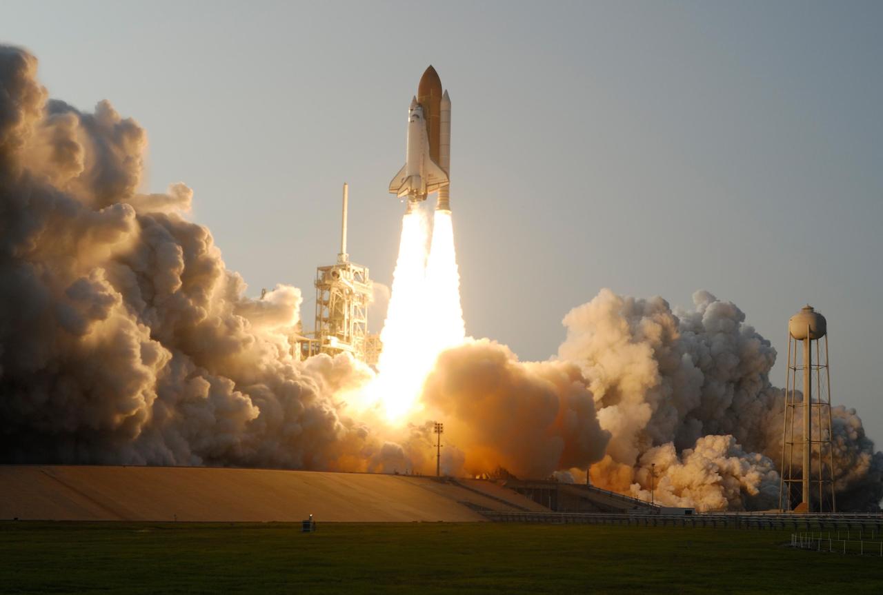 KENNEDY SPACE CENTER, FLA. -- Clouds of smoke and steam roil across Launch Pad 39A as Space Shuttle Endeavour hurtles into the early evening sky on mission STS-118. The liftoff was on time at 6:36 p.m. EDT.  The mission is the 22nd shuttle flight to the International Space Station. It will continue space station construction by delivering a third starboard truss segment, S5, and other payloads such as the SPACEHAB module and the external stowage platform 3.  The 11-day mission may be extended to as many as 14 depending on the test of the Station-to-Shuttle Power Transfer System that will allow the docked shuttle to draw electrical power from the station and extend its visits to the orbiting lab.  Photo courtesy of Nikon/Scott Andrews