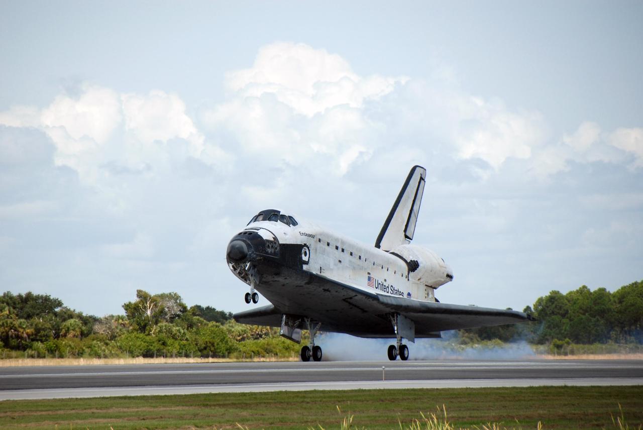 KENNEDY SPACE CENTER, FLA. --   Endeavour kicks up dust as it touches down on runway 15 at NASA's Kennedy Space Center. The Space Shuttle Endeavour crew, led by Commander Scott Kelly, completes a 13-day mission to the International Space Station.  The STS-118 mission began Aug. 8 and installed a new gyroscope, an external spare parts platform and another truss segment to the expanding station.  Endeavour's main gear touched down at 12:32:16  p.m. EDT.  Nose gear touchdown was at 12:32:29 p.m. and wheel stop was at 12:33:20 p.m.  Endeavour traveled nearly 5.3 million miles, landing on orbit 201. STS-118 was the 119th space shuttle flight, the 22nd flight to the station, the 20th flight for Endeavour and the second of four missions planned for 2007. This was the 65th landing of an orbiter at Kennedy.  Photo credit: NASA/Kim Shiflett