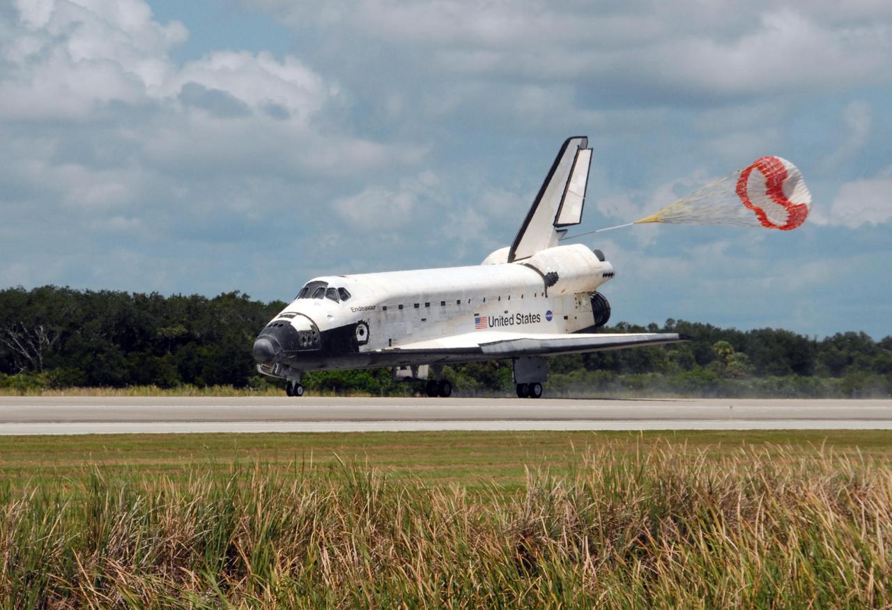 KENNEDY SPACE CENTER, FLA. -- The opening drag chute helps slow Endeavour as it lands on runway 15 at NASA's Kennedy Space Center. The Space Shuttle Endeavour crew, led by Commander Scott Kelly, completes a 13-day mission to the International Space Station. The STS-118 mission began Aug. 8 and installed a new gyroscope, an external spare parts platform and another truss segment to the expanding station. Endeavour's main gear touched down at 12:32:16 p.m. EDT. Nose gear touchdown was at 12:32:29 p.m. and wheel stop was at 12:33:20 p.m. Endeavour traveled nearly 5.3 million miles, landing on orbit 201. STS-118 was the 119th space shuttle flight, the 22nd flight to the station, the 20th flight for Endeavour and the second of four missions planned for 2007. This was the 65th landing of an orbiter at Kennedy. Photo credit: NASA/George Shelton