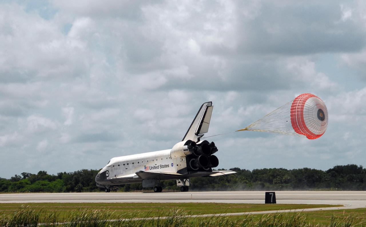KENNEDY SPACE CENTER, FLA. -- The open drag chute helps slow Endeavour as it lands on runway 15 at NASA's Kennedy Space Center. The Space Shuttle Endeavour crew, led by Commander Scott Kelly, completes a 13-day mission to the International Space Station. The STS-118 mission began Aug. 8 and installed a new gyroscope, an external spare parts platform and another truss segment to the expanding station. Endeavour's main gear touched down at 12:32:16 p.m. EDT. Nose gear touchdown was at 12:32:29 p.m. and wheel stop was at 12:33:20 p.m. Endeavour traveled nearly 5.3 million miles, landing on orbit 201. This was the 65th landing of an orbiter at Kennedy. Photo credit: NASA/George Shelton